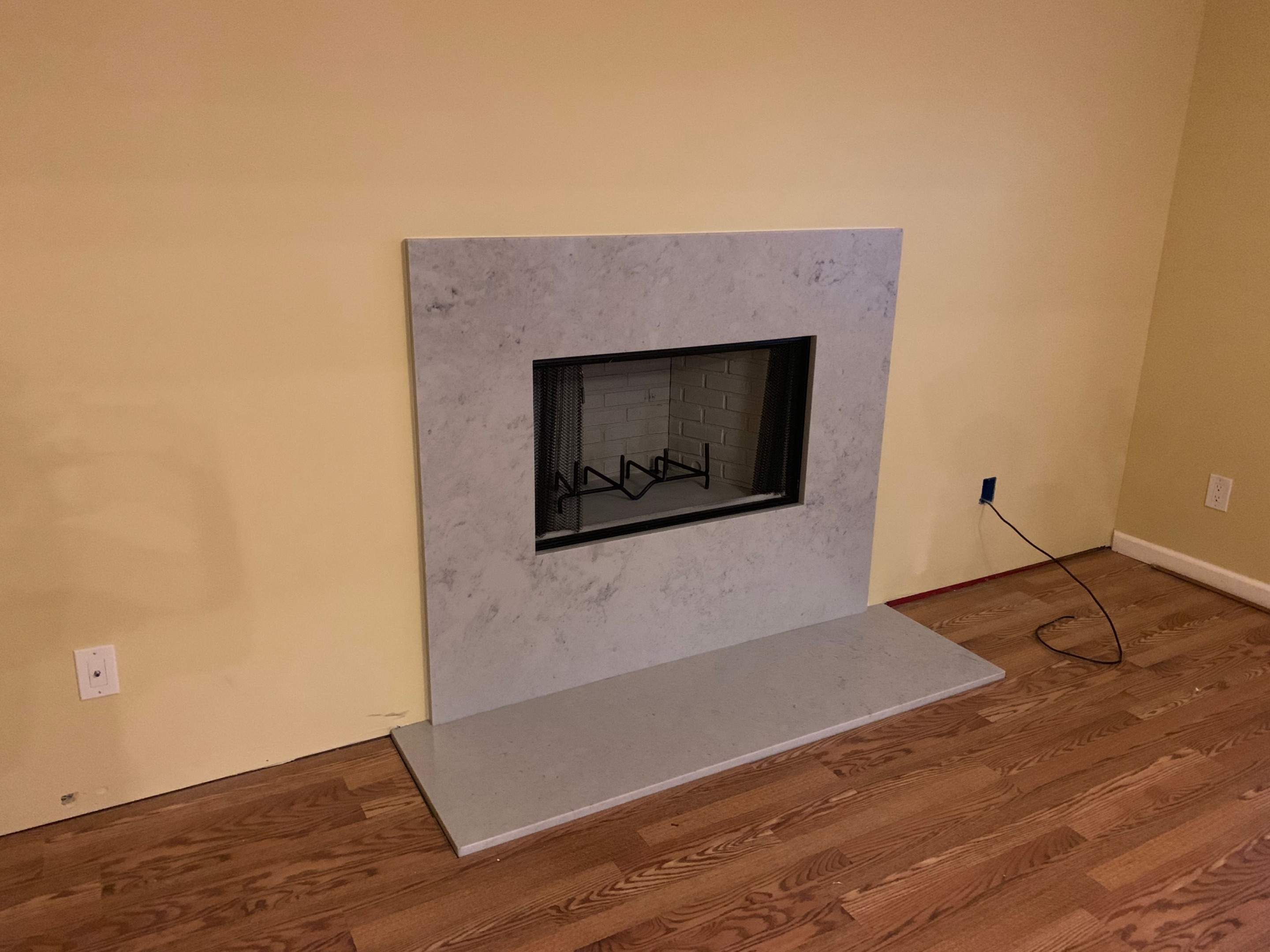 Wood Fireplace + Granite by Premier Chimney and Roofing