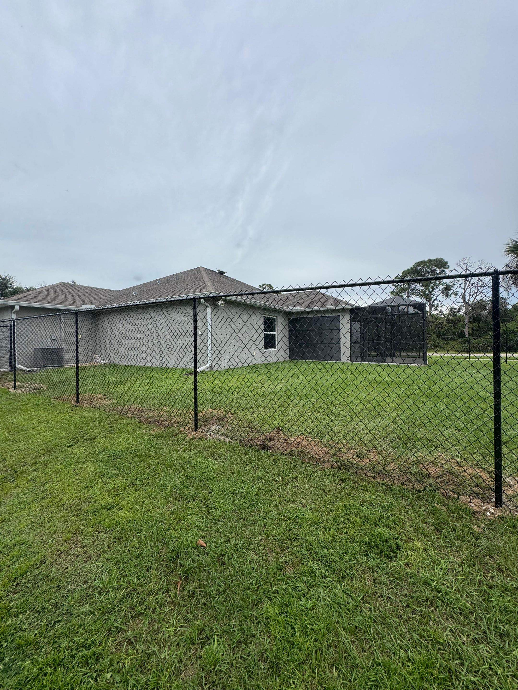 Black Chain Link Boundary Fence with Access Gates in North Port by True Fence LLC