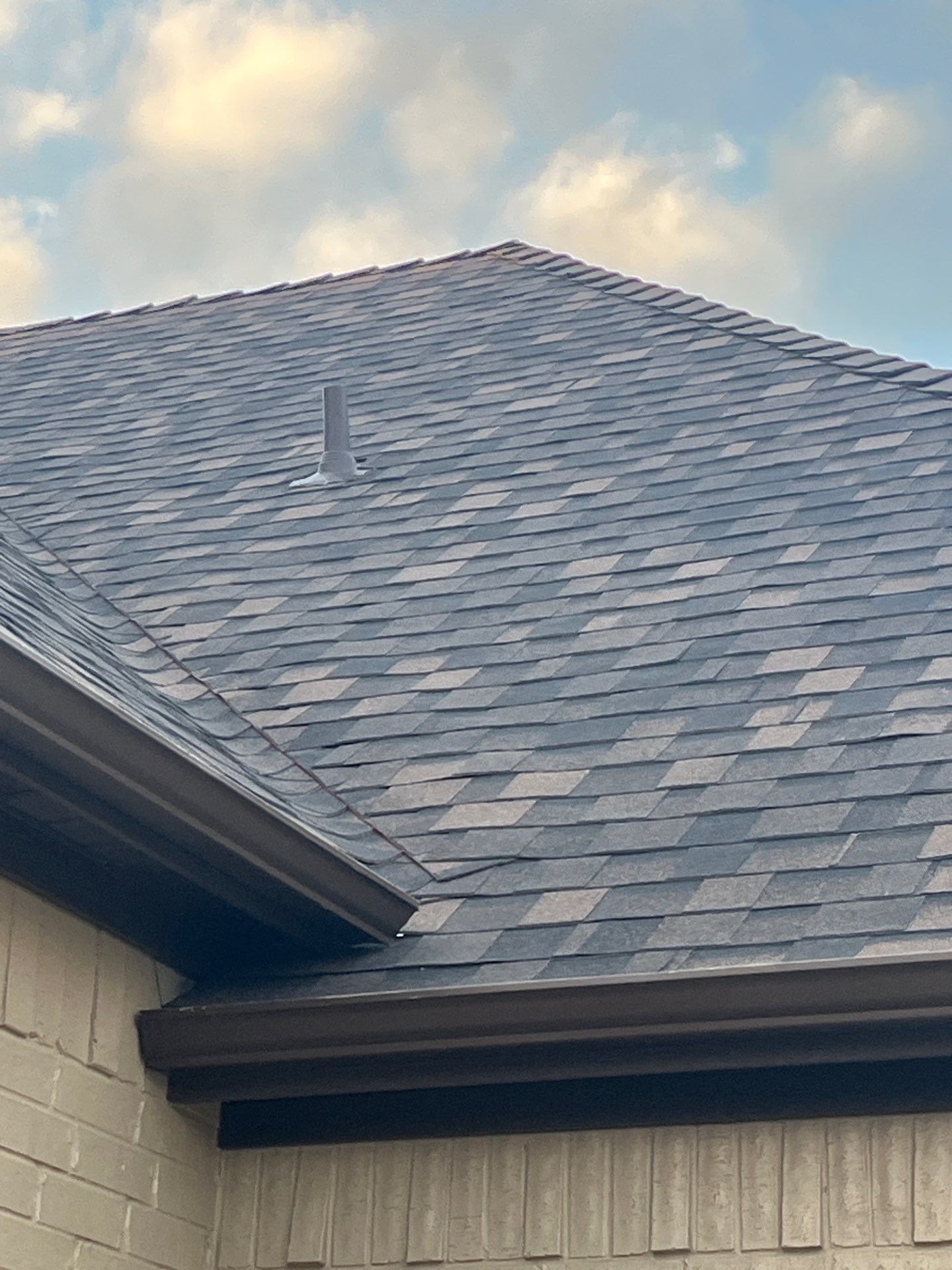 Cream brick/mixed stone with IKO Shadow Brown by Tejas Roofworks + Restoration