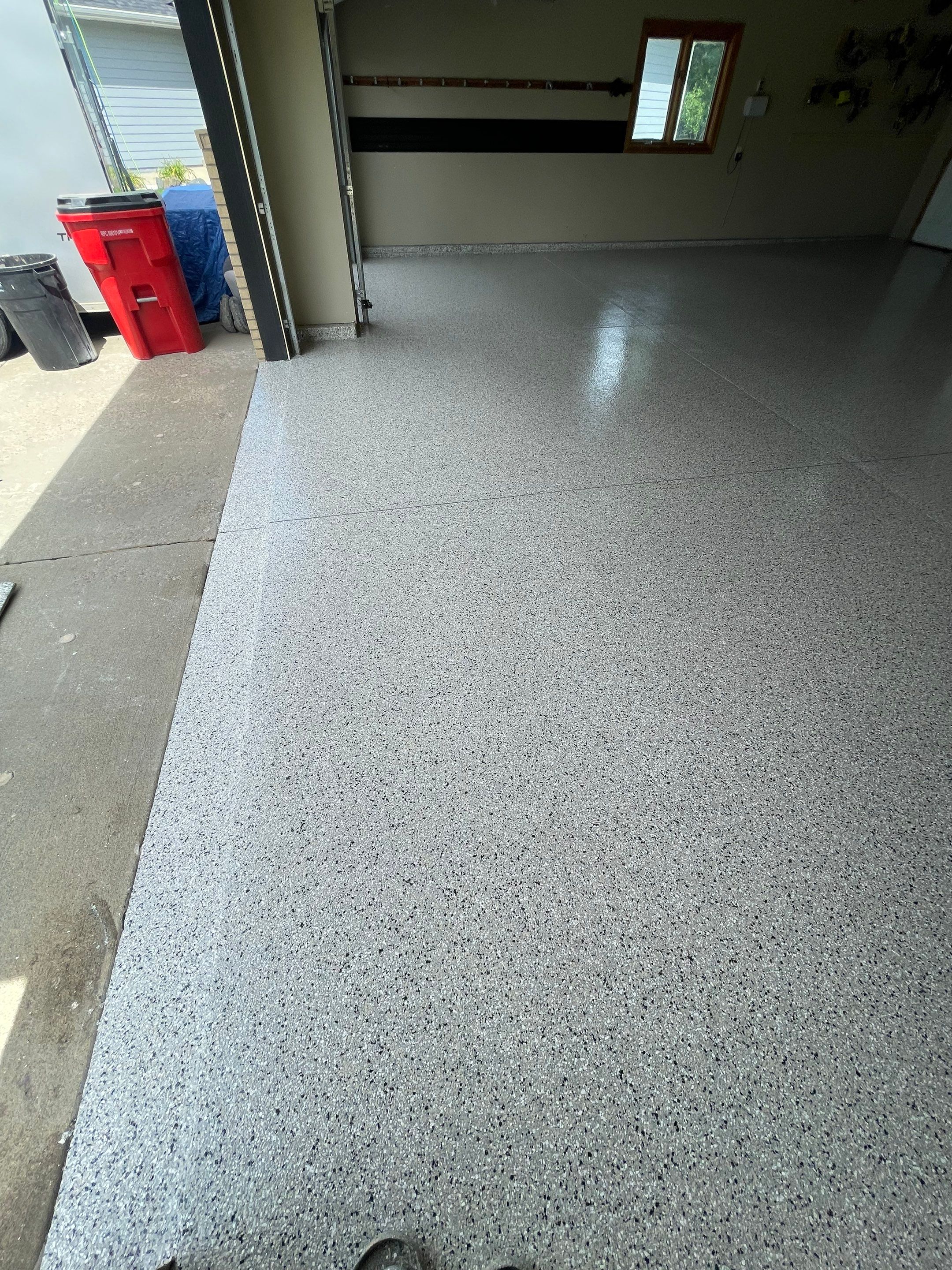 Cabin FEver Flake Garage Floor Coating Installation in Sioux Falls by Select Painting, Coatings & Garage Cabinets