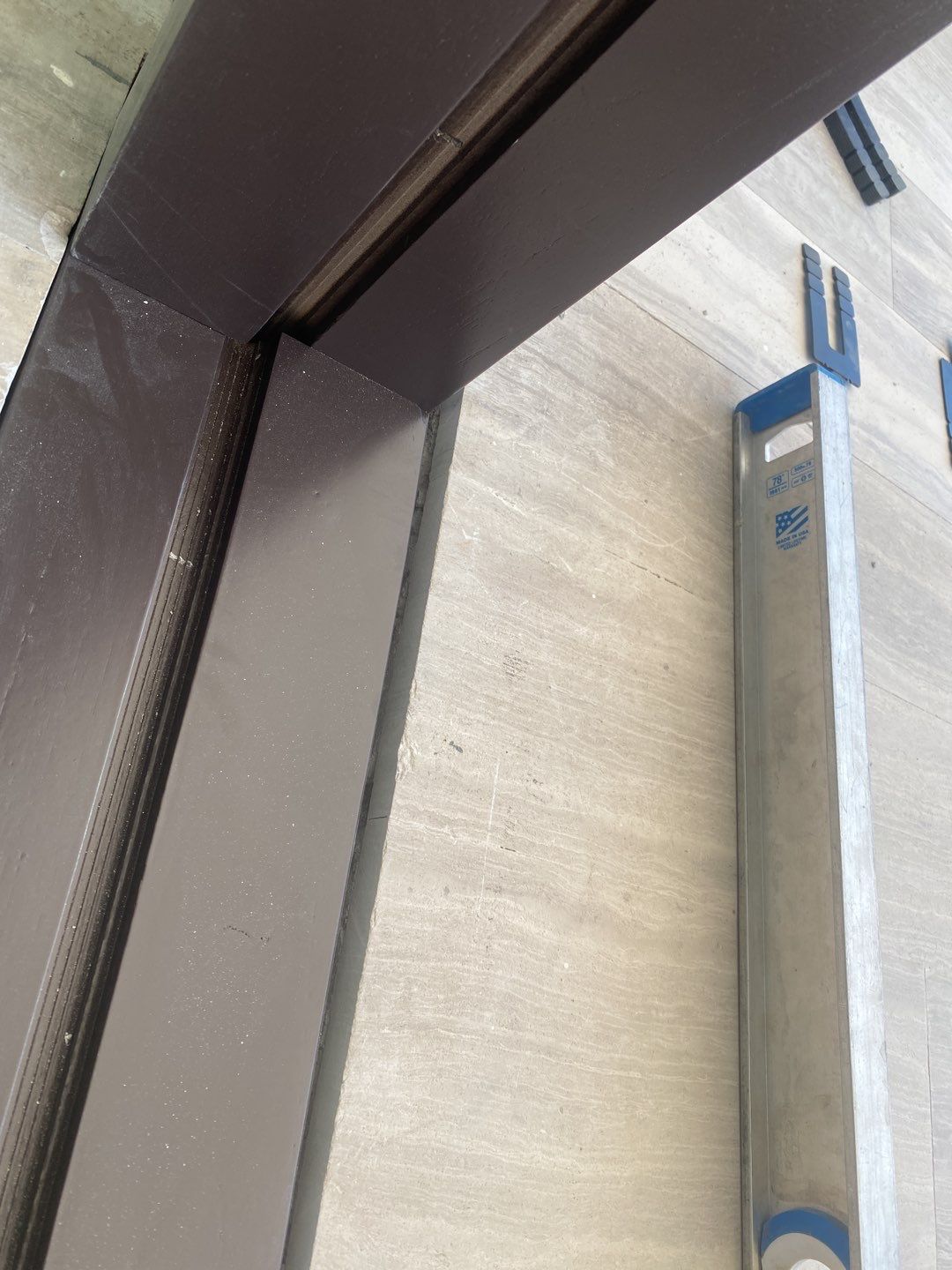 Custom Material Pivot Door installation by Impact Precious Wood Inc.