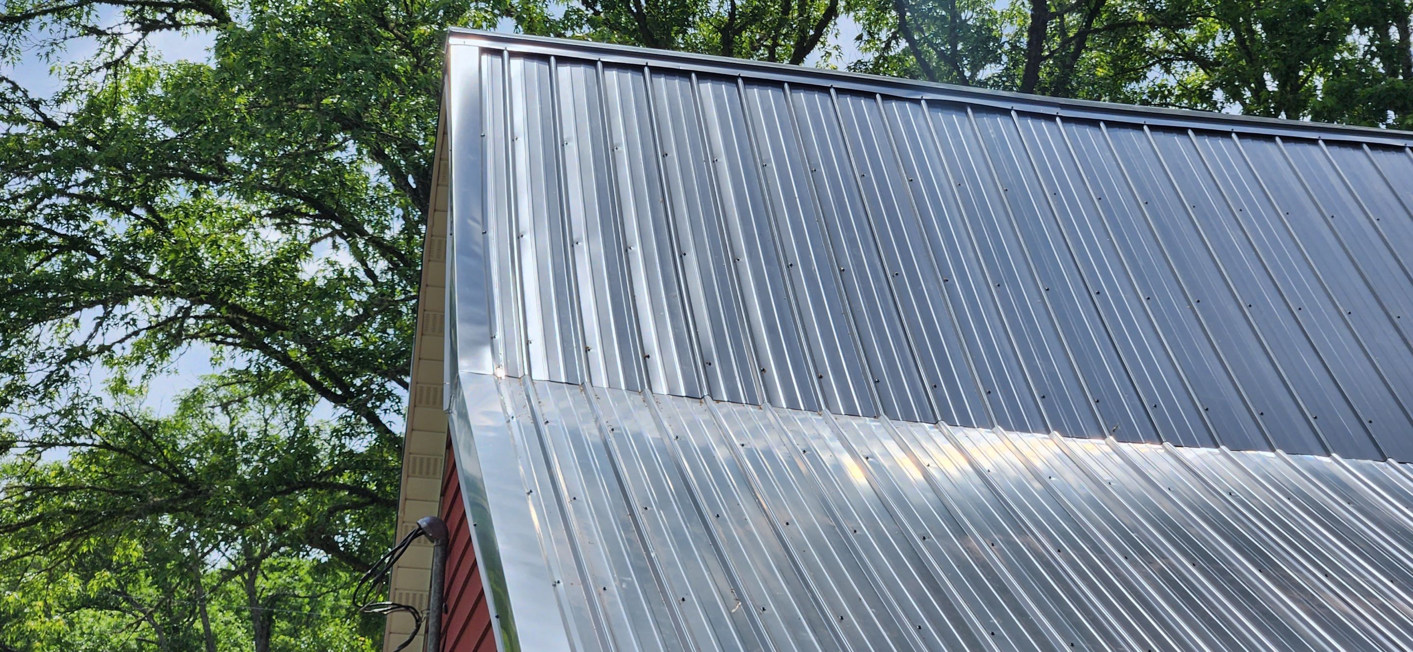 Residential Roofing Installation using 26 Gauge Colored Panels by Hostetler Roofing