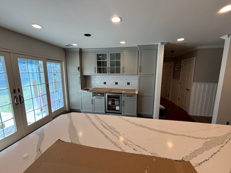 Herringbone Floor install w/ Subway Tile Backsplash by Footprints Floors Morristown