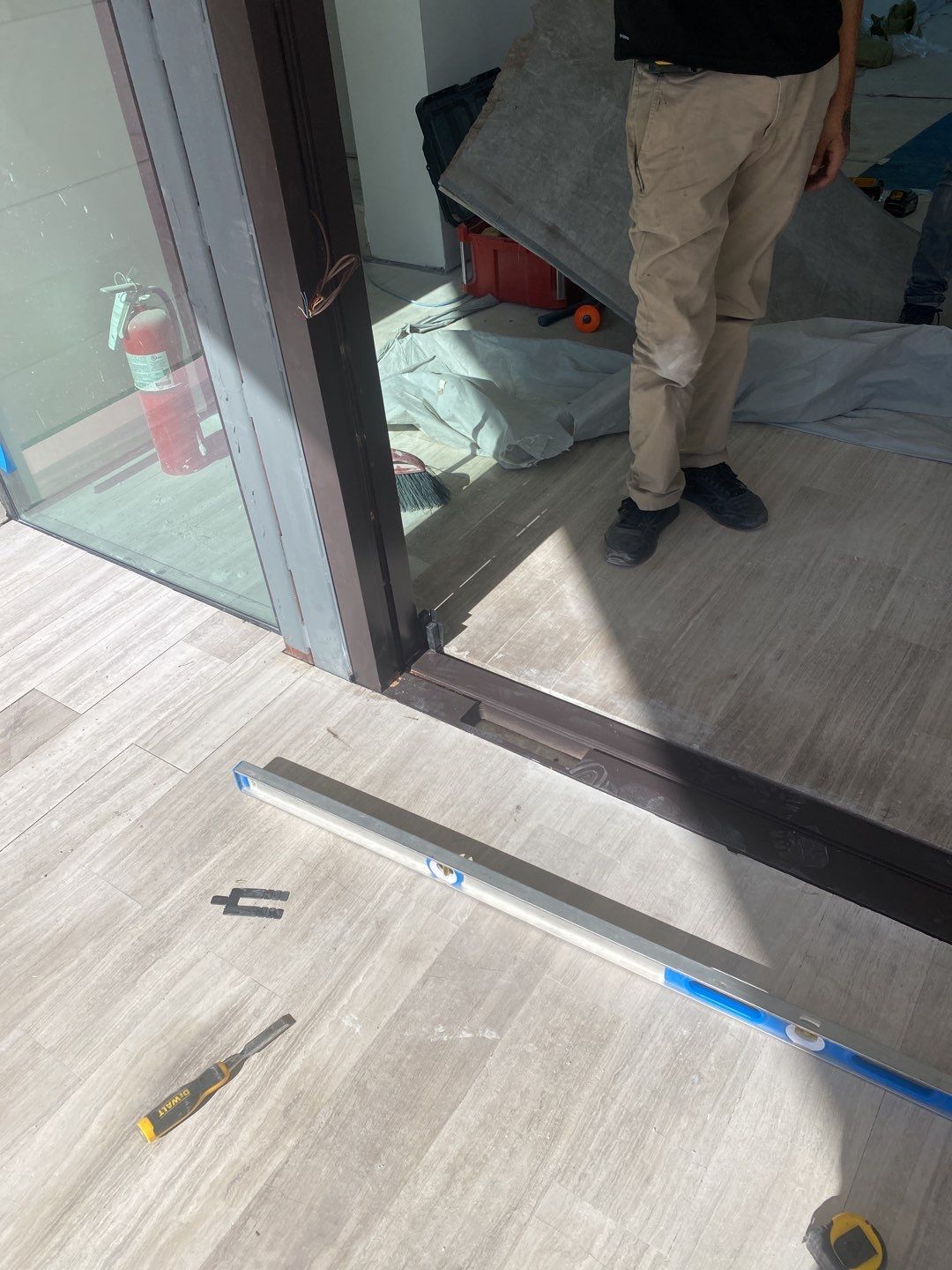 Custom Material Pivot Door installation by Impact Precious Wood Inc.