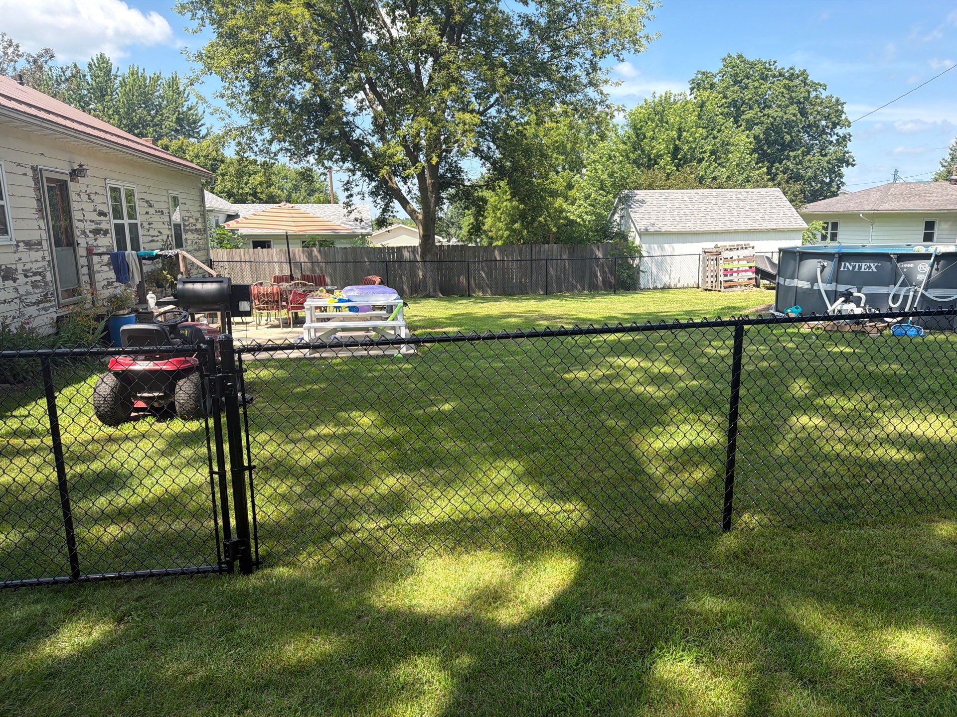 Black Chain Link Backyard Fence Installation in Tripoli, IA by Perfect Picket Fence and Stain