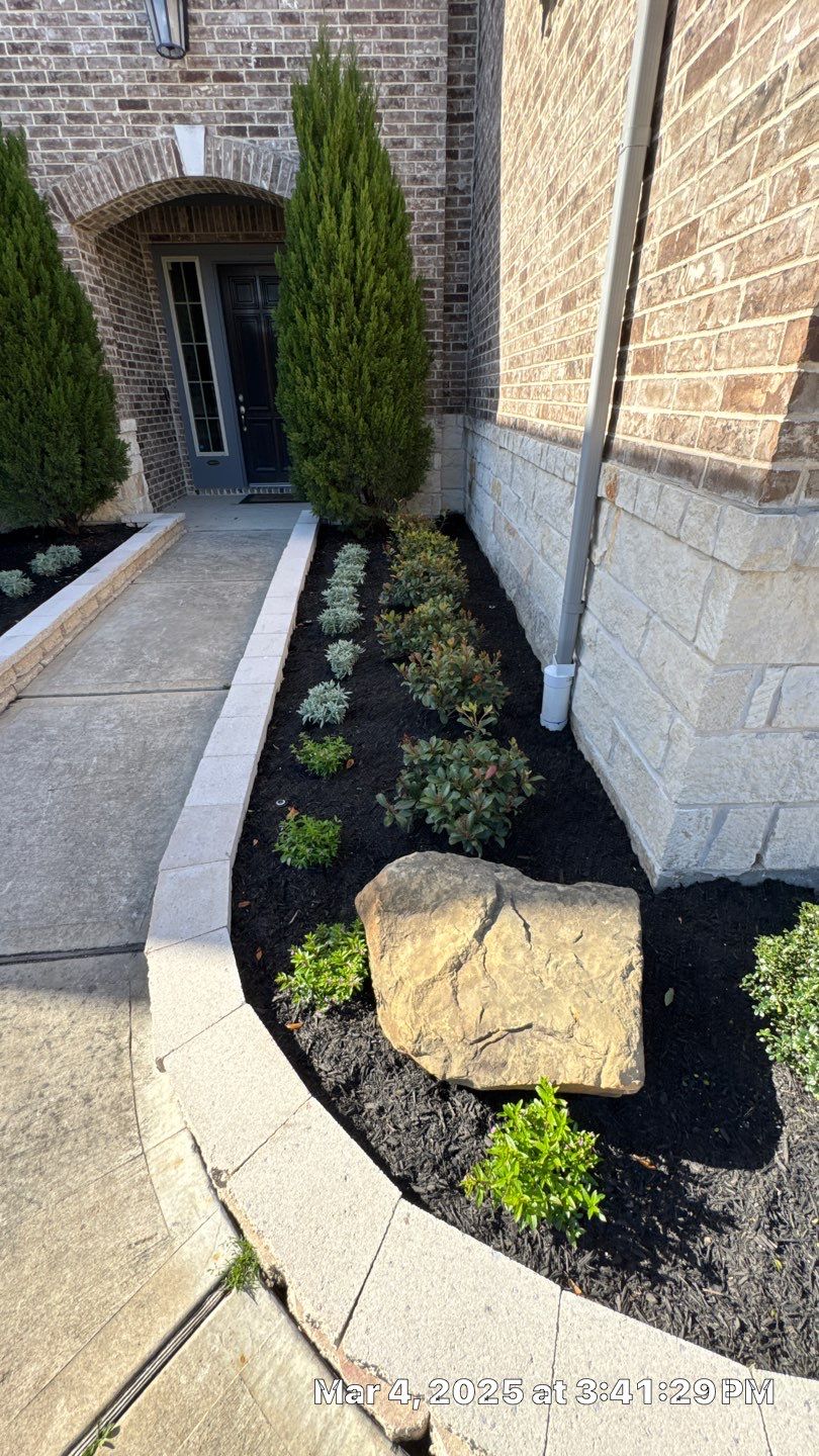 🌿✨ Darlene & Andrew’s Amazing Curb Appeal Transformation  Some projects are more than just landscaping—they’re a conversion of curb appeal from the ground up. For Darlene & Andrew, Alejandro and the Texas Urban Team designed and delivered a complete solution that reshaped their flower beds, solved drainage challenges, and gave new life to the sideyard.  💡 From planning to execution, every step was tailored to build both beauty and functionality:  🌸 Flower Beds, Reinvented  Demolition of old beds, plants, and mulch.  Fresh soil preparation, weed protection, and a brand-new retainer wall built with hand-cut stone and decorative caps.  Carefully selected plants and garden mix to ensure health and visual harmony.  💧 Drainage & Irrigation Upgrades  Outdated corrugated pipes replaced with PVC drainage lines to carry water safely away from the foundation.  New irrigation system combining drip lines and sprinklers—watering plants while keeping the house walls protected.  Sideyard drainage extended with catch basins and PVC piping to prevent water pooling and foundation stress.  🚶 Functional Sideyard with Walkway & Trash Area  Graded and leveled sideyard to manage runoff.  Installed a modern gravel and paver walkway for easy access.  Built a firm and tidy concrete-paver pad for trash containers—making the space both practical and polished.  🛠️ Stonework & Craftsmanship  Every stone in the retainer wall was cut, set, and secured by the team of handcrafters, ensuring a durable build that doubles as a design statement.  ✅ Outcome: Darlene & Andrew’s property now has better drainage, a clean and organized sideyard, and elegant new flower beds—all designed for long-term durability and lasting beauty.  📢 Before hiring anyone, review our portfolio. Our work speaks louder than words—each project is a blend of function, protection, and design crafted to last. by Texas Urban Elements
