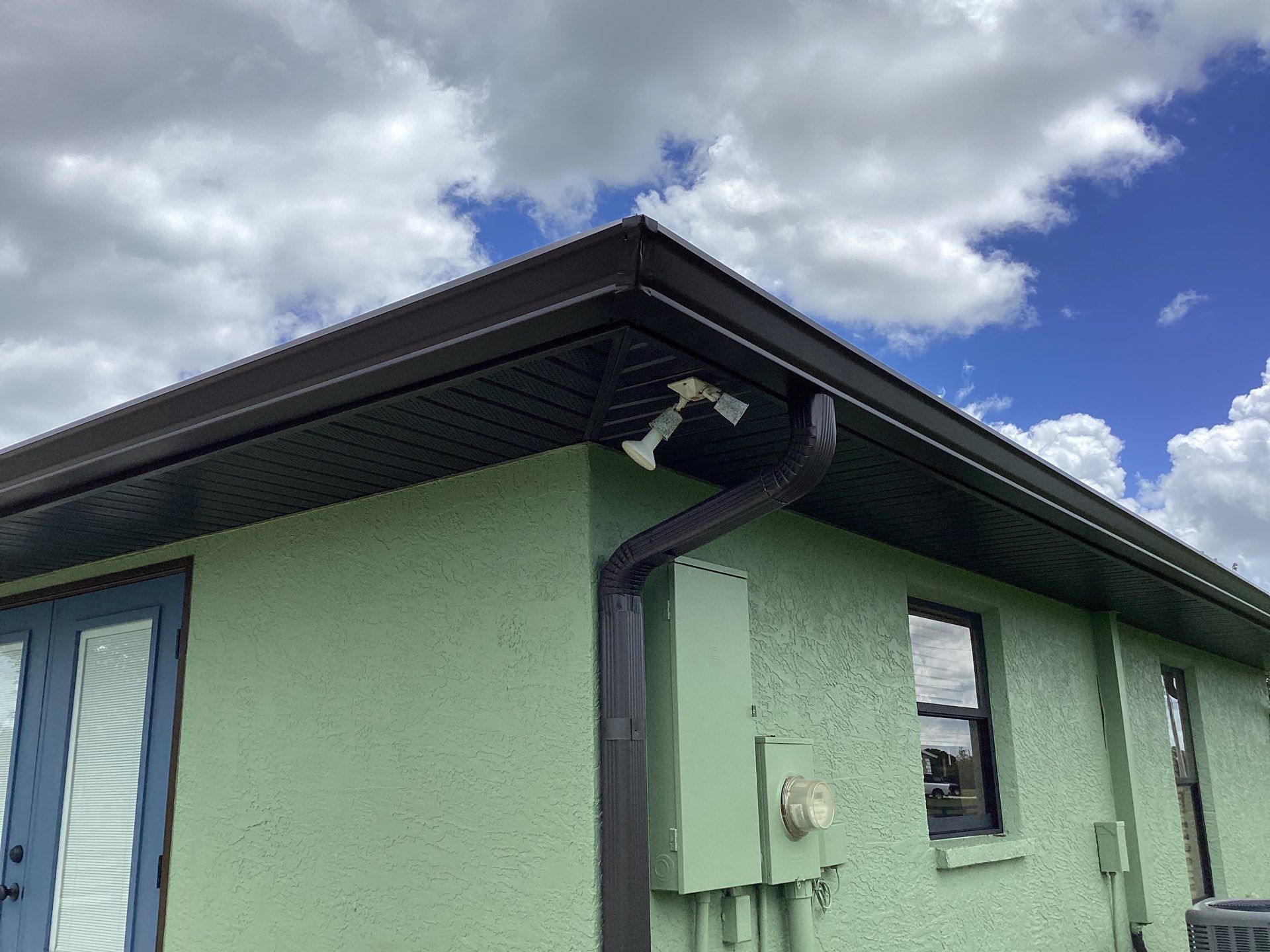 Musket brown downspouts with 6-inch K-Style gutter installation in Myakka City, FL by Gutter Professors