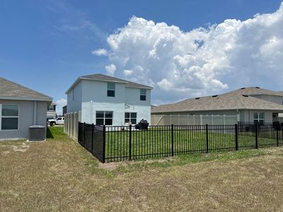 Aluminum Fence Installation using Black 3 Rail Aluminum Fence and Tan Vinyl Privacy Fence