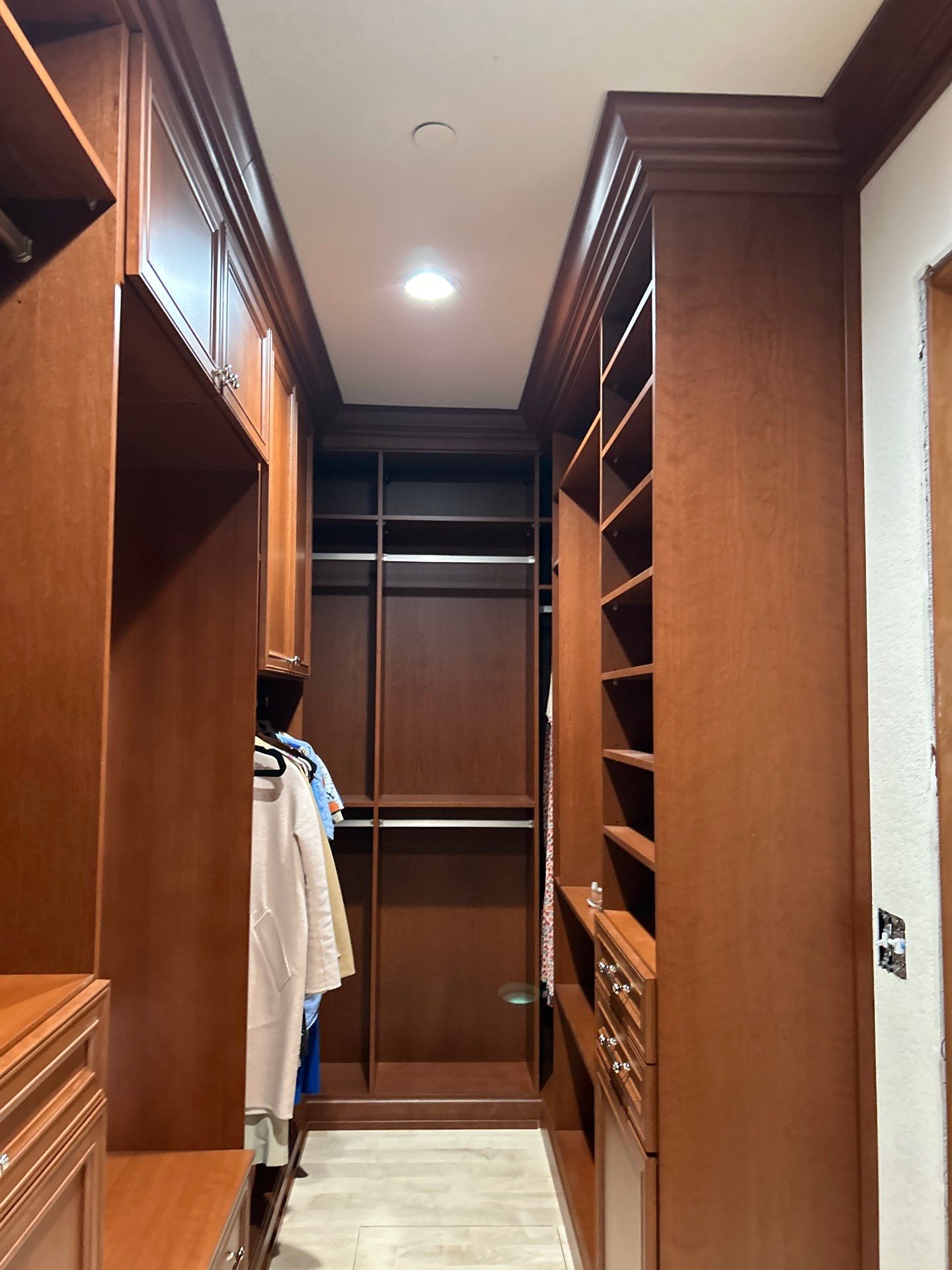 Stained Cherry Wood Primary Closet by Concept 32, Inc.