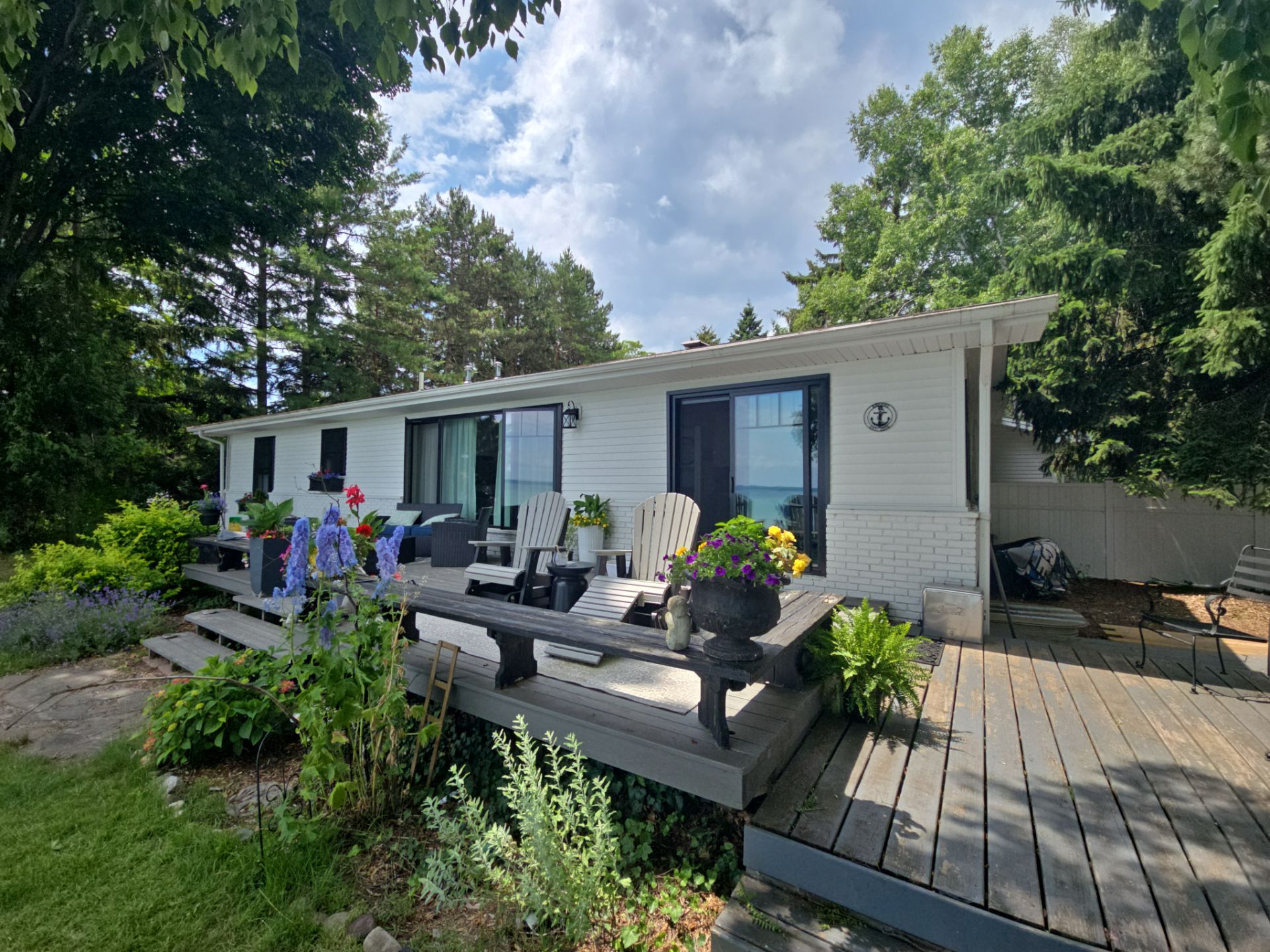 Black Gutter and Gutter Helmet Installation for Suttons Bay Home by Rainbow Seamless Systems