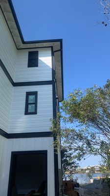Seamless Gutter Installation Using Black Half Round Seamless Gutters