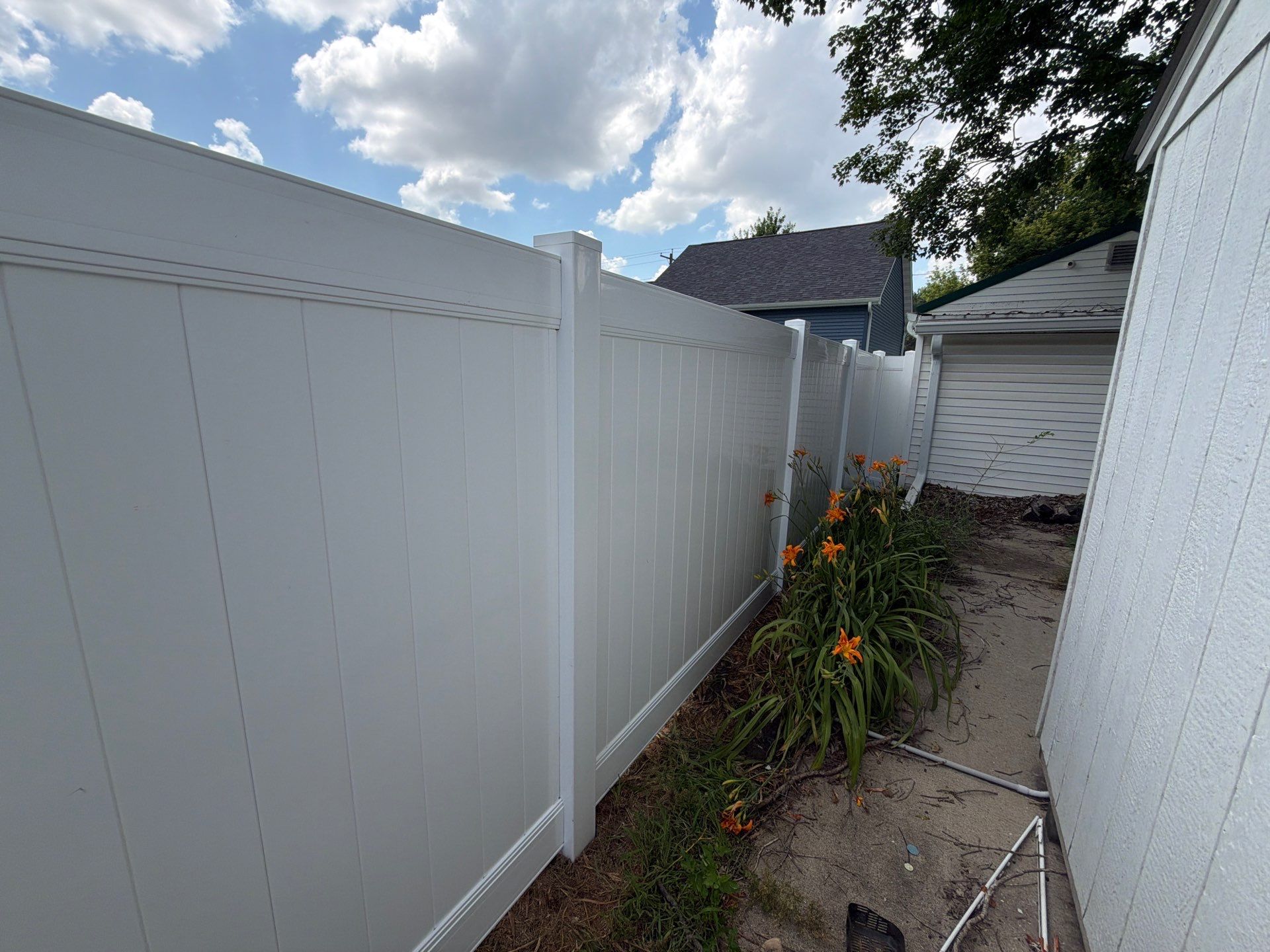 White Vinyl Privacy Fence Installation in Waterloo, Iowa by Perfect Picket Fence and Stain