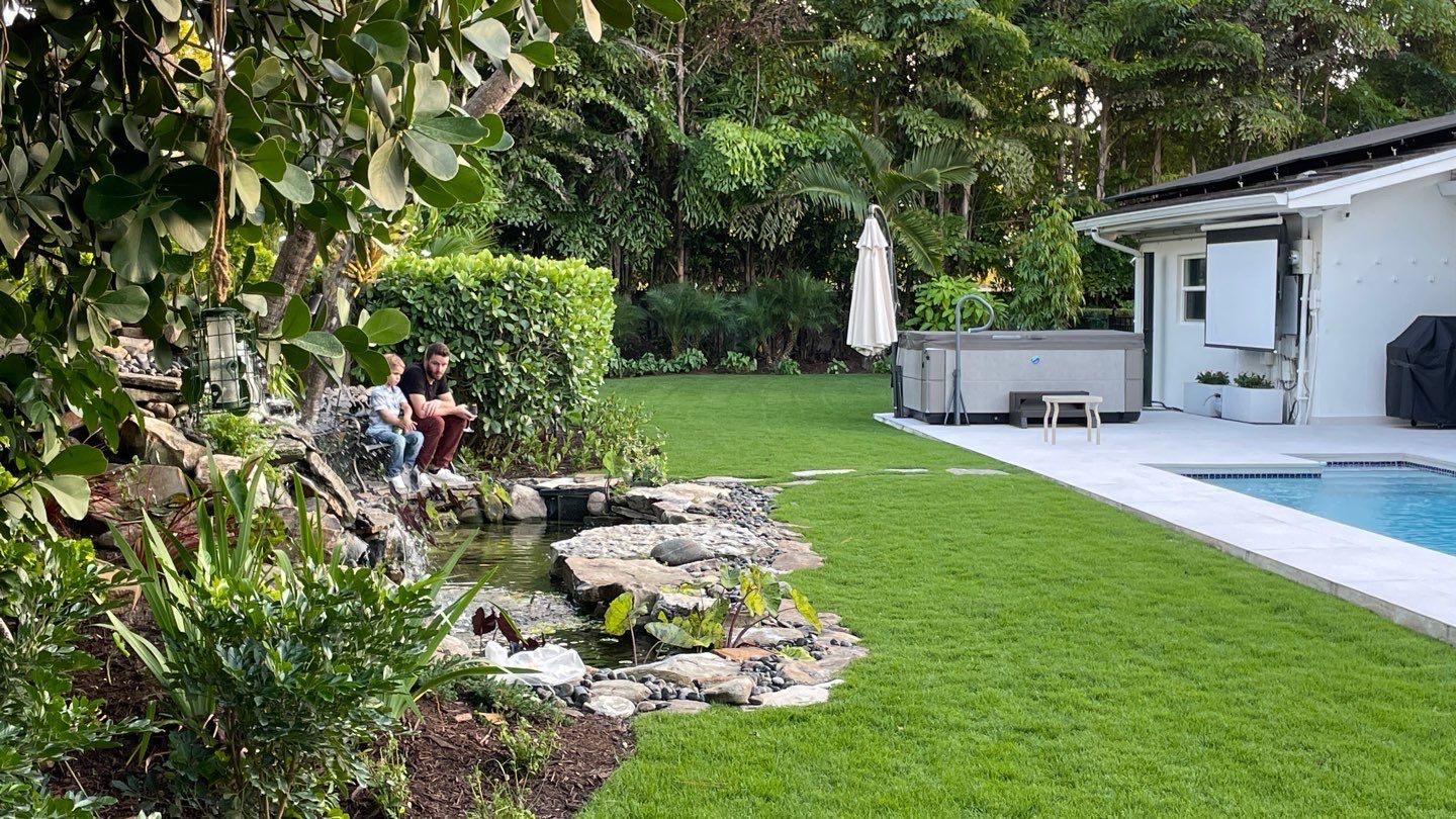 A Beautiful Relaxing Koi Pond with Waterfall in Pinecrest by Nature's Dream Landscape and Tree Service