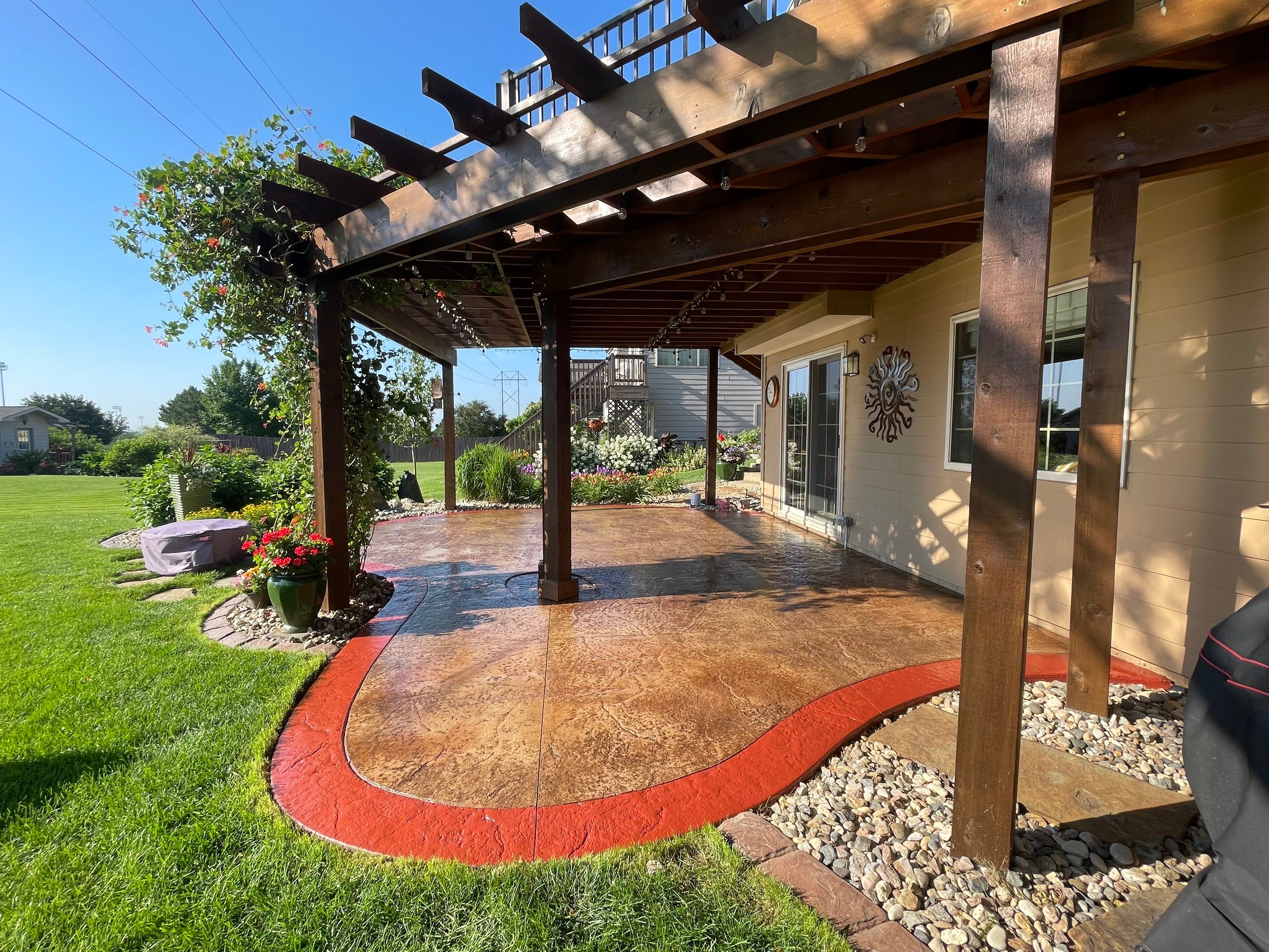 Custom Stamped Concrete Patio and Wood Pergola in Sioux Falls by Select Painting, Coatings & Garage Cabinets