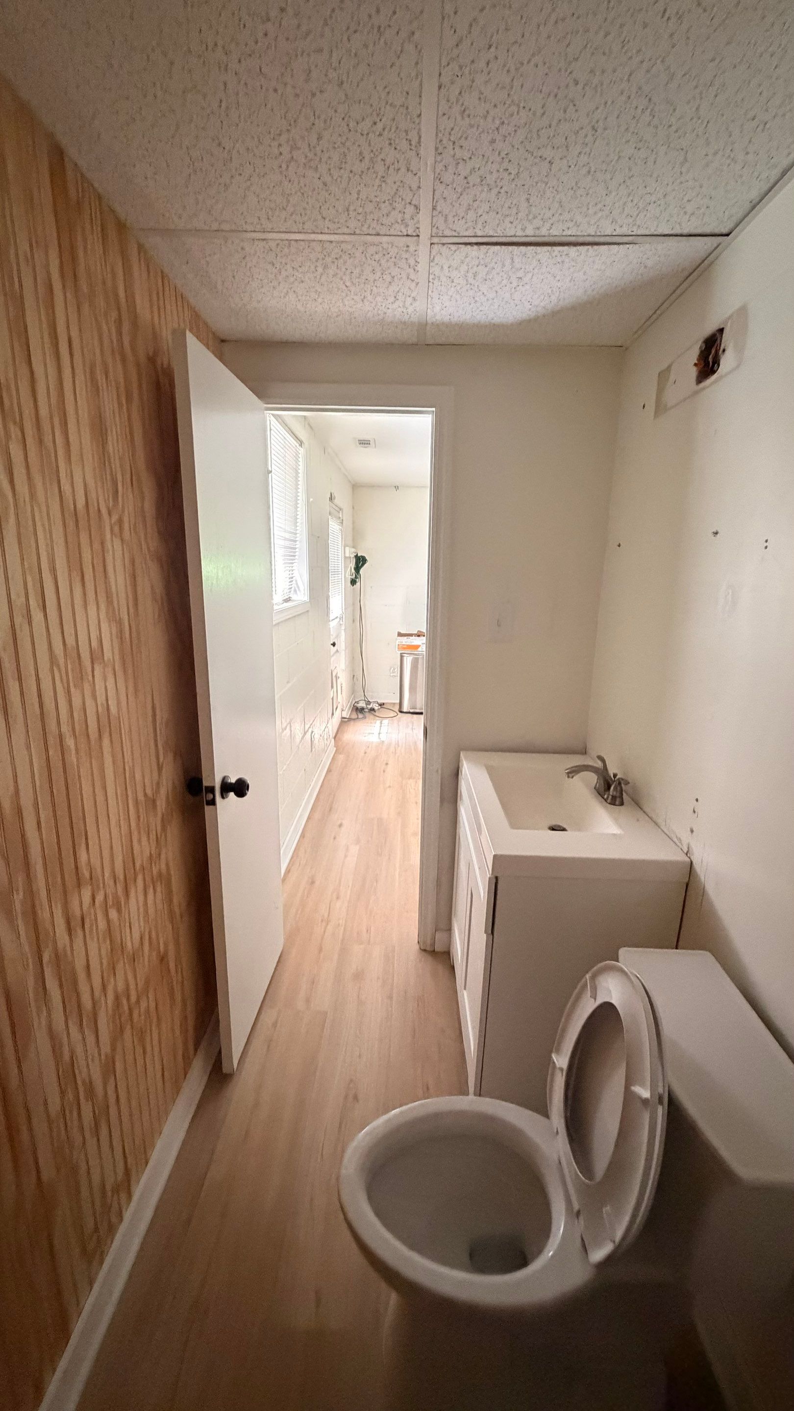 Basement Remodeling with Wood-Look Flooring and Custom Wainscoting in Dunwoody by Swift Home Renovations