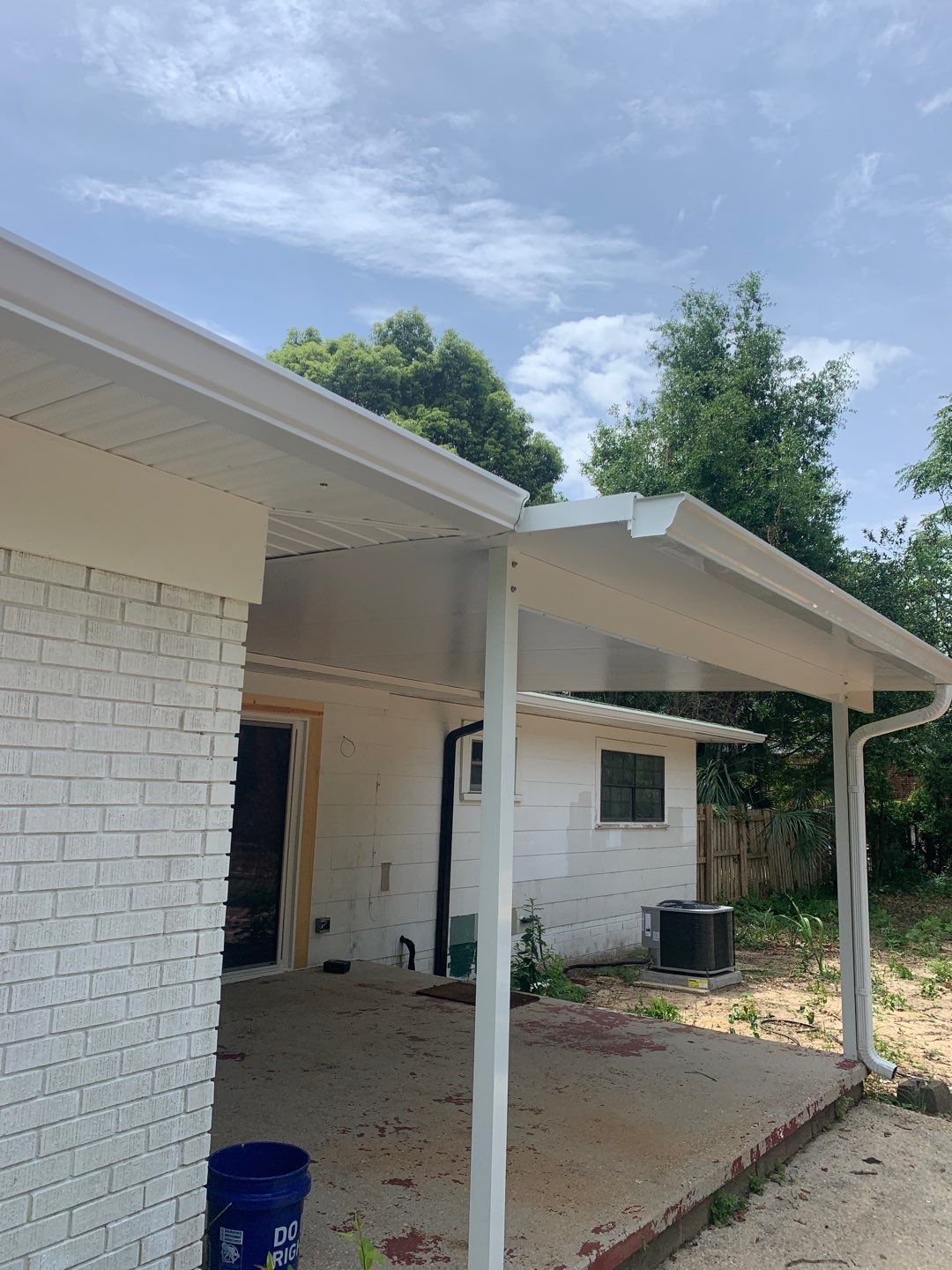 White Seamless Gutters and Black Downspouts by Gutter Professors