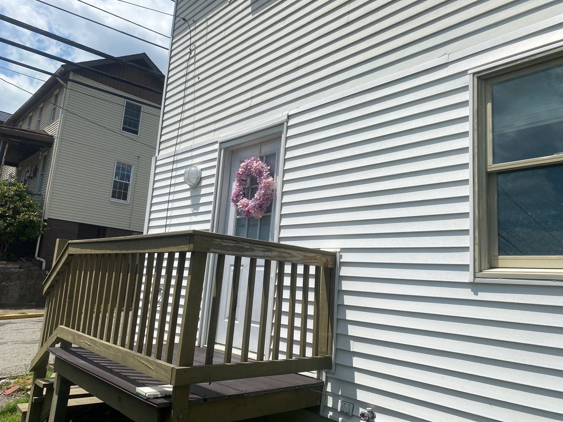 White siding  by Cousins Roofing Siding & Decks