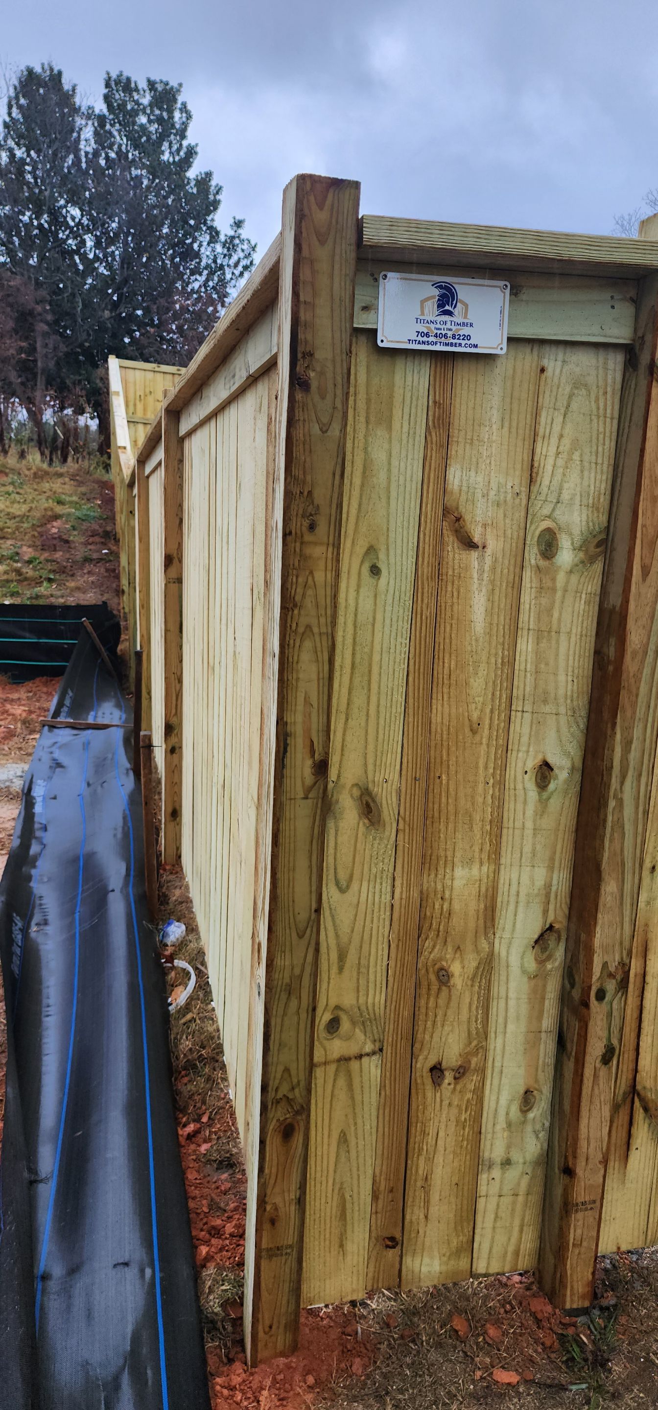 Fence Installation of Capped Wood Privacy by Titans of Timber Fence & Stain