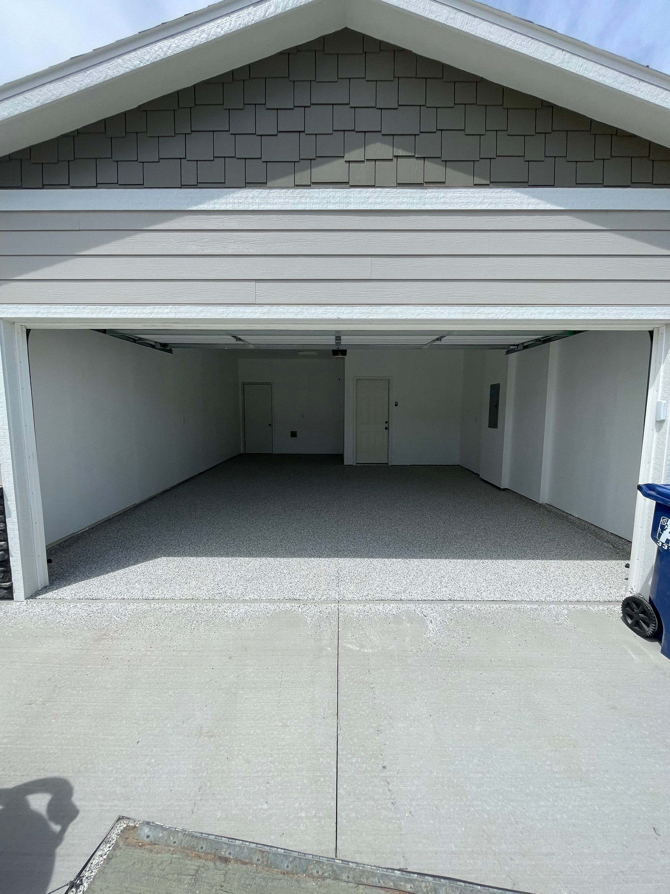 Sioux Falls Garage Floor Transformation with Cabin Fever Decorative Chips by Select Painting, Coatings & Garage Cabinets