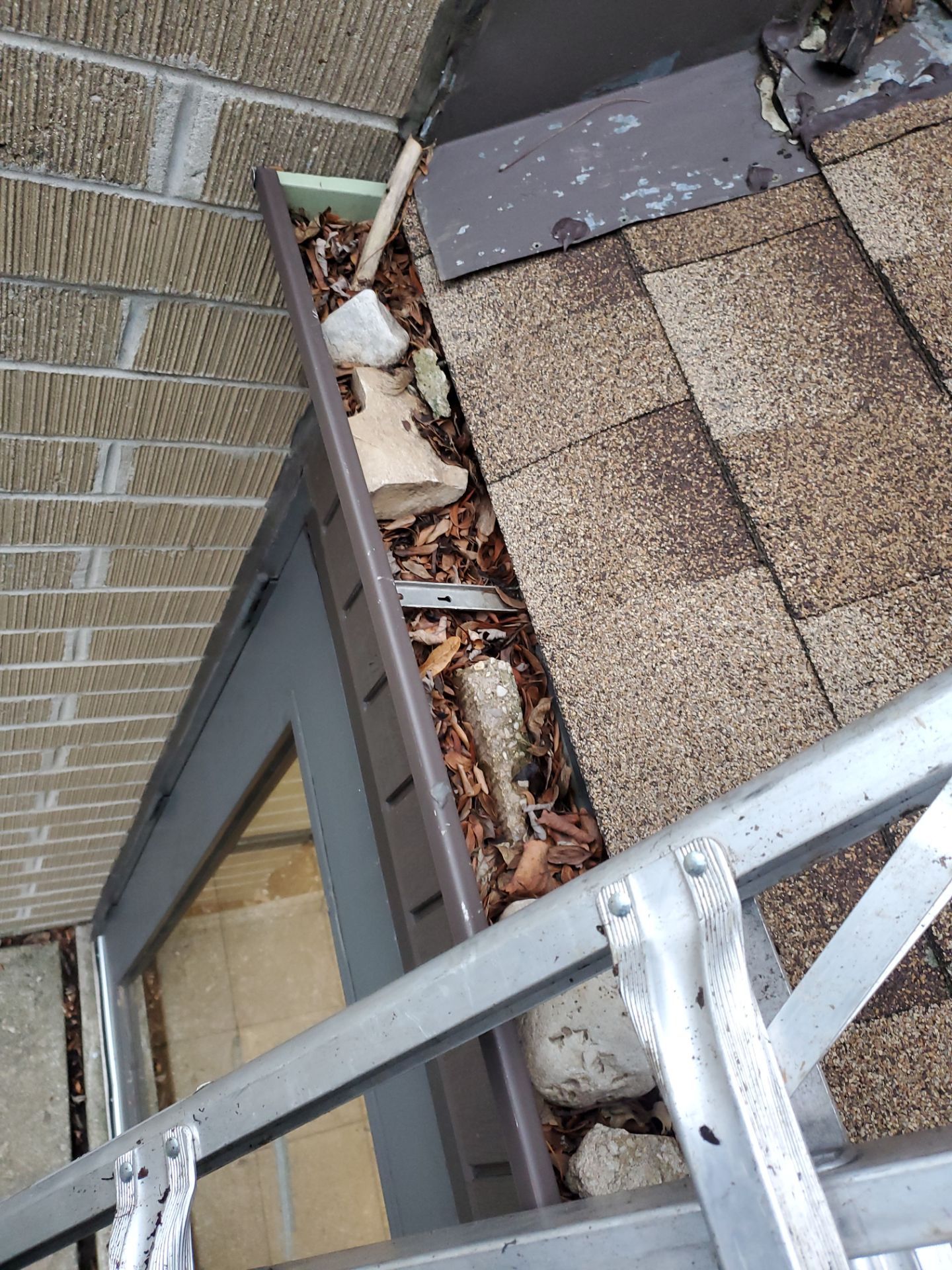 Commercial gutter cleaning Milwaukee before photo with filled gutters