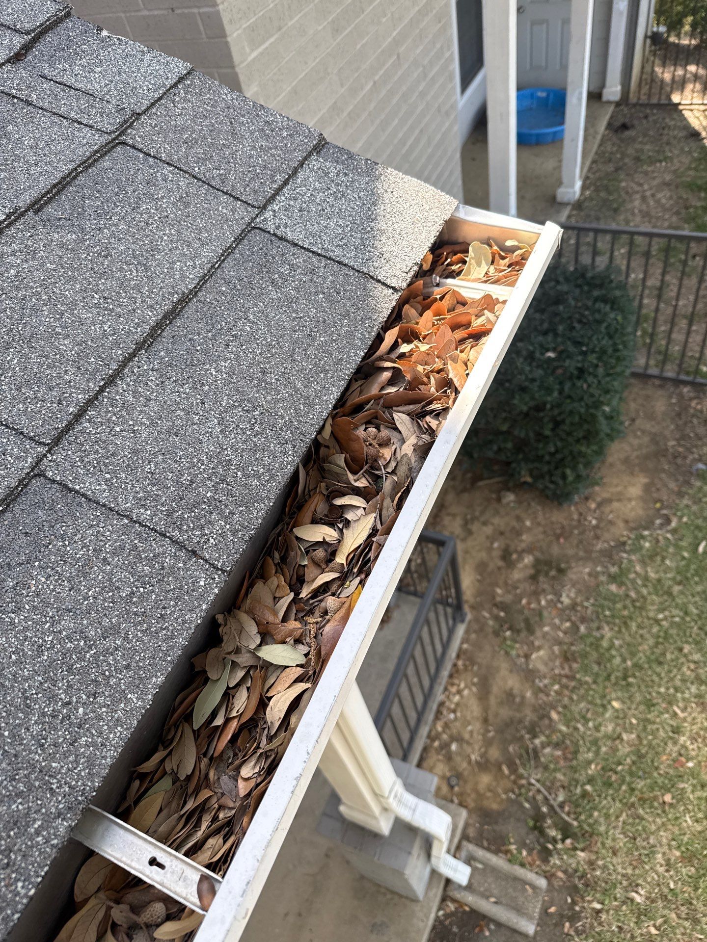 HOA gutter cleaning in Flower Mound & Lewisville, TX,before  photo showing full gutters.