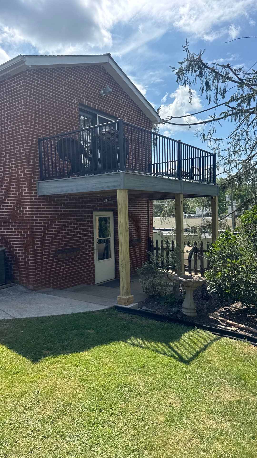 Elevated Composite Deck Rebuild with Black Metal Railing in Lewisburg by Walnut Hollow Decks & Outdoor Living
