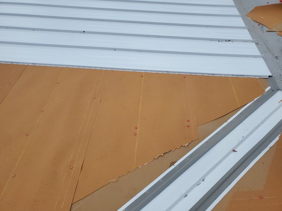 Residential Roofing Installation using 1.5" Nail Strip 24ga Solar White Kynar Coated Standing Seam Metal Panels by Morton Roofing, Inc.