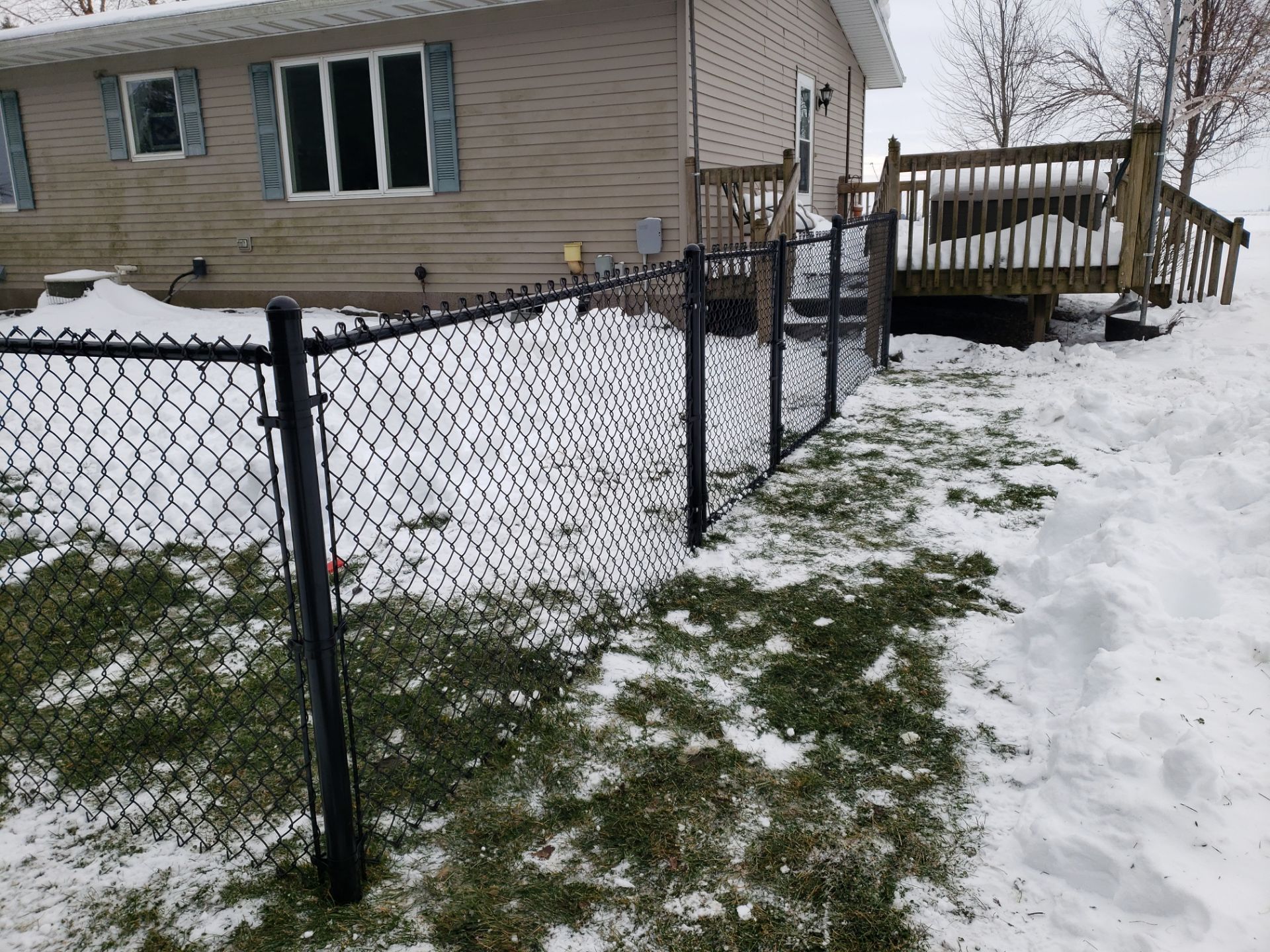 Black Vinyl-Coated Chain Link Fence Installation in Oelwein by Perfect Picket Fence and Stain