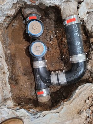 The replacement of a crumbing leaky house u-trap in basement