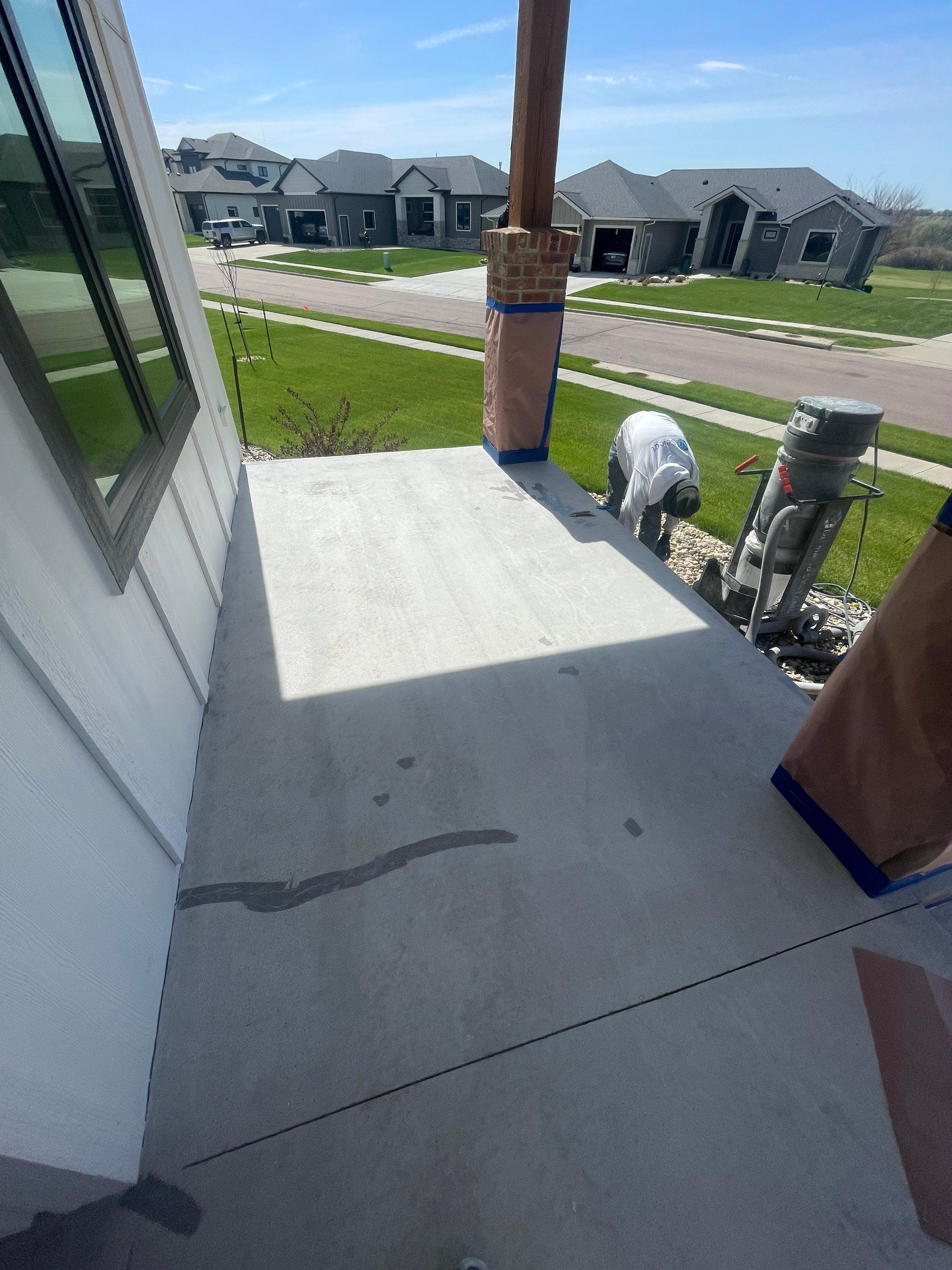 Grey Speckled Concrete Porch Coating for Sioux Falls Home by Select Painting, Coatings & Garage Cabinets