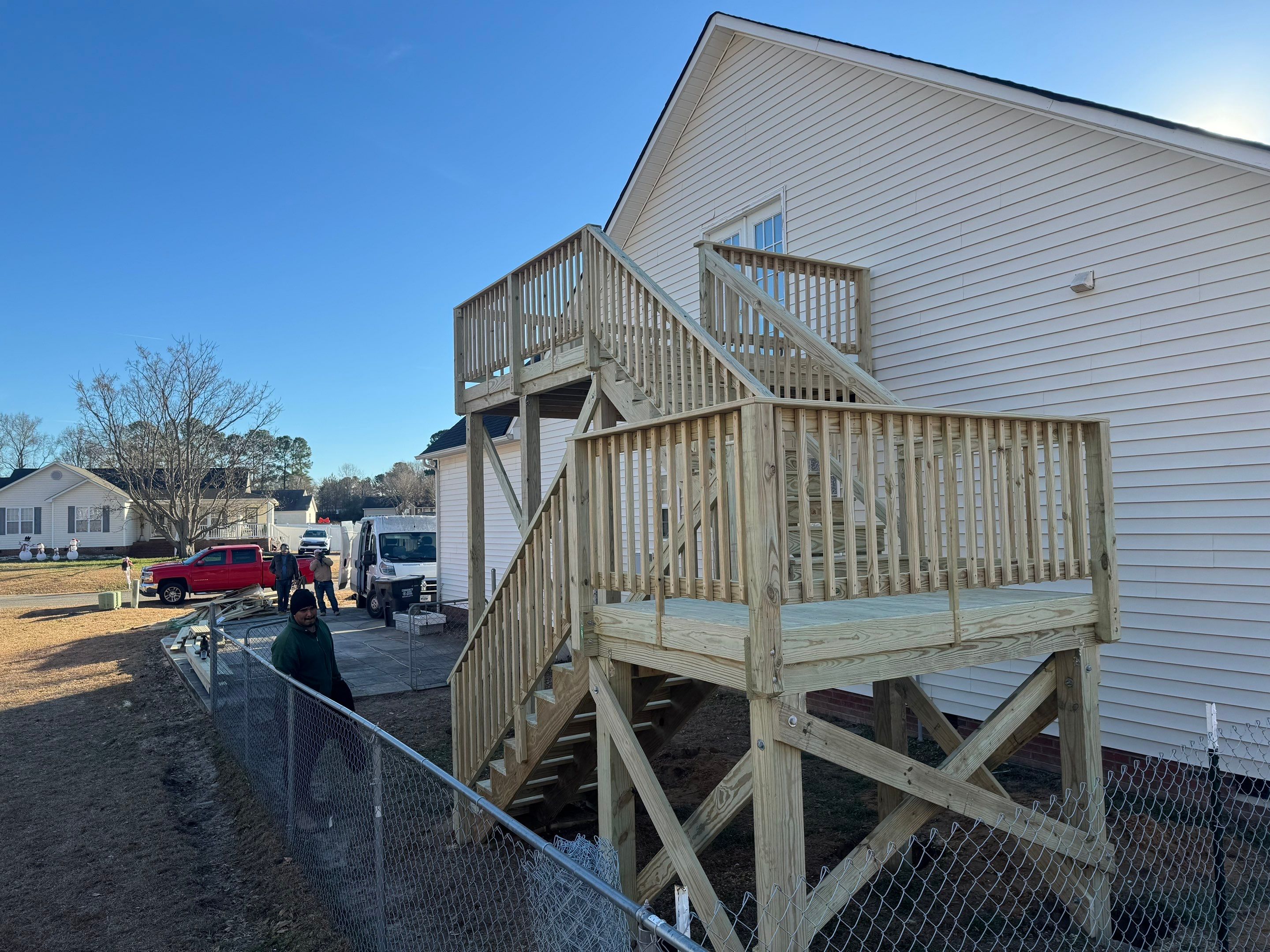 Elevated Pressure-Treated Wood Deck and Sliding Glass Door Installation in Clayton by The Remodeling Company