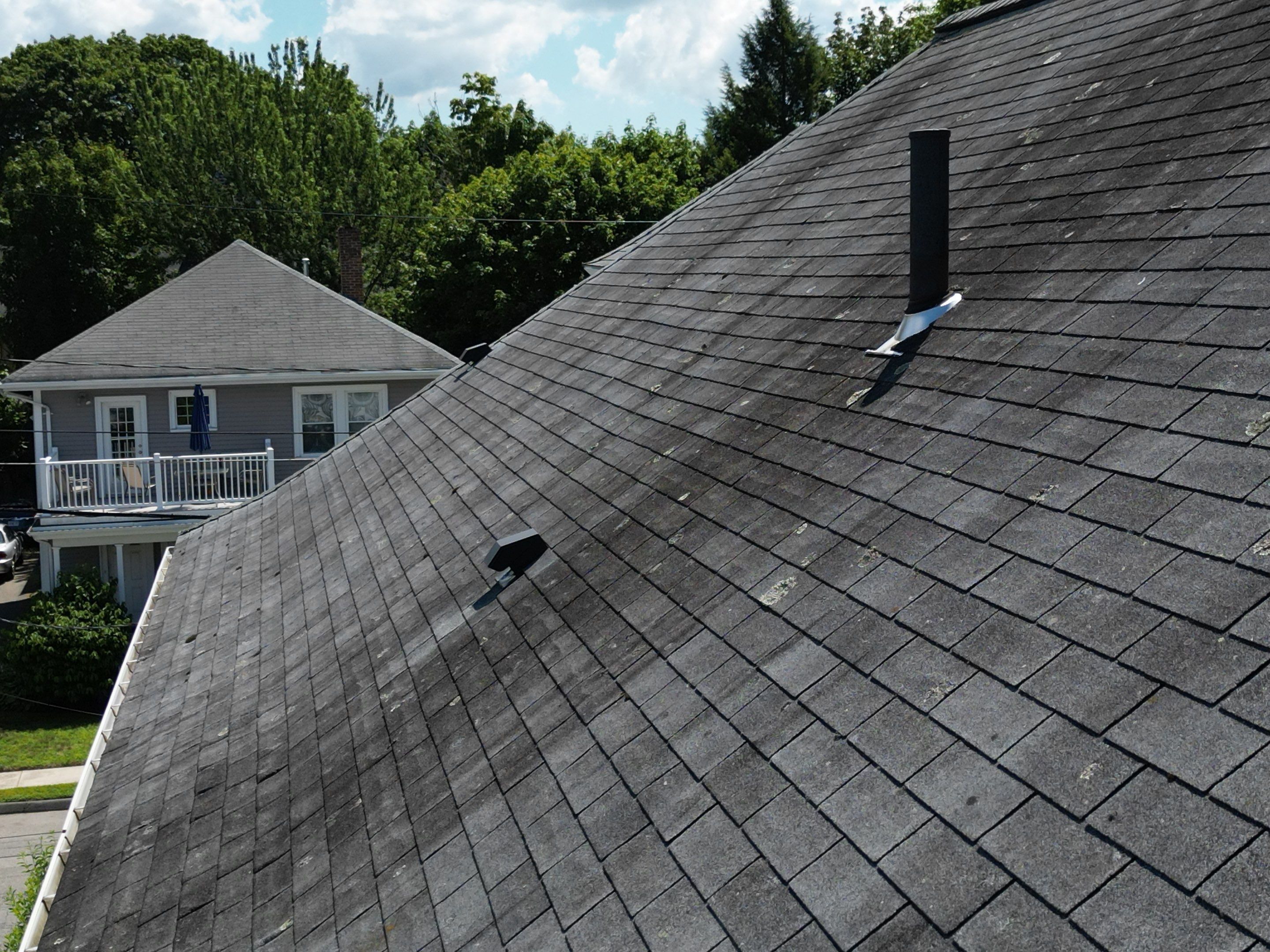 Roof Replacement with Skylight Flashing in Waltham, MA by Mighty Dog Roofing of Greater Middlesex County
