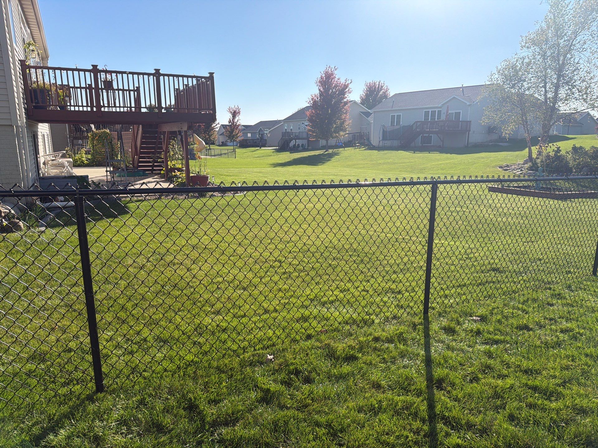 Black Vinyl-Coated Chain Link Fence Installation in Cedar Falls by Perfect Picket Fence and Stain