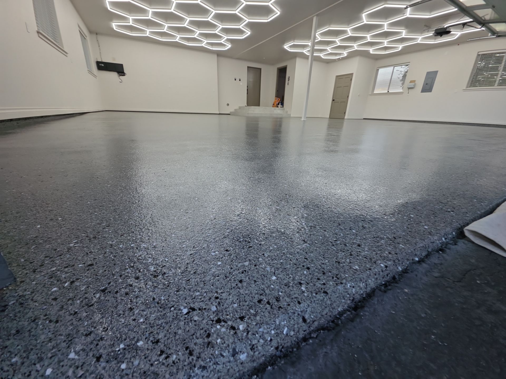 Custom Garage Transformation with Polyaspartic Coating and Hexagonal LED Lighting by Croc Coatings, LLC