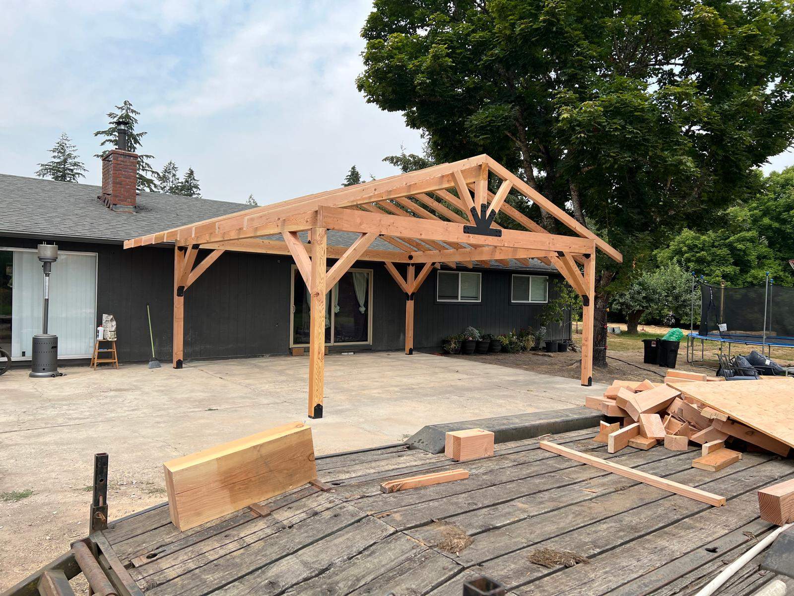 Custom Timber Frame Patio Cover with Black Metal Roof by American Made Construction