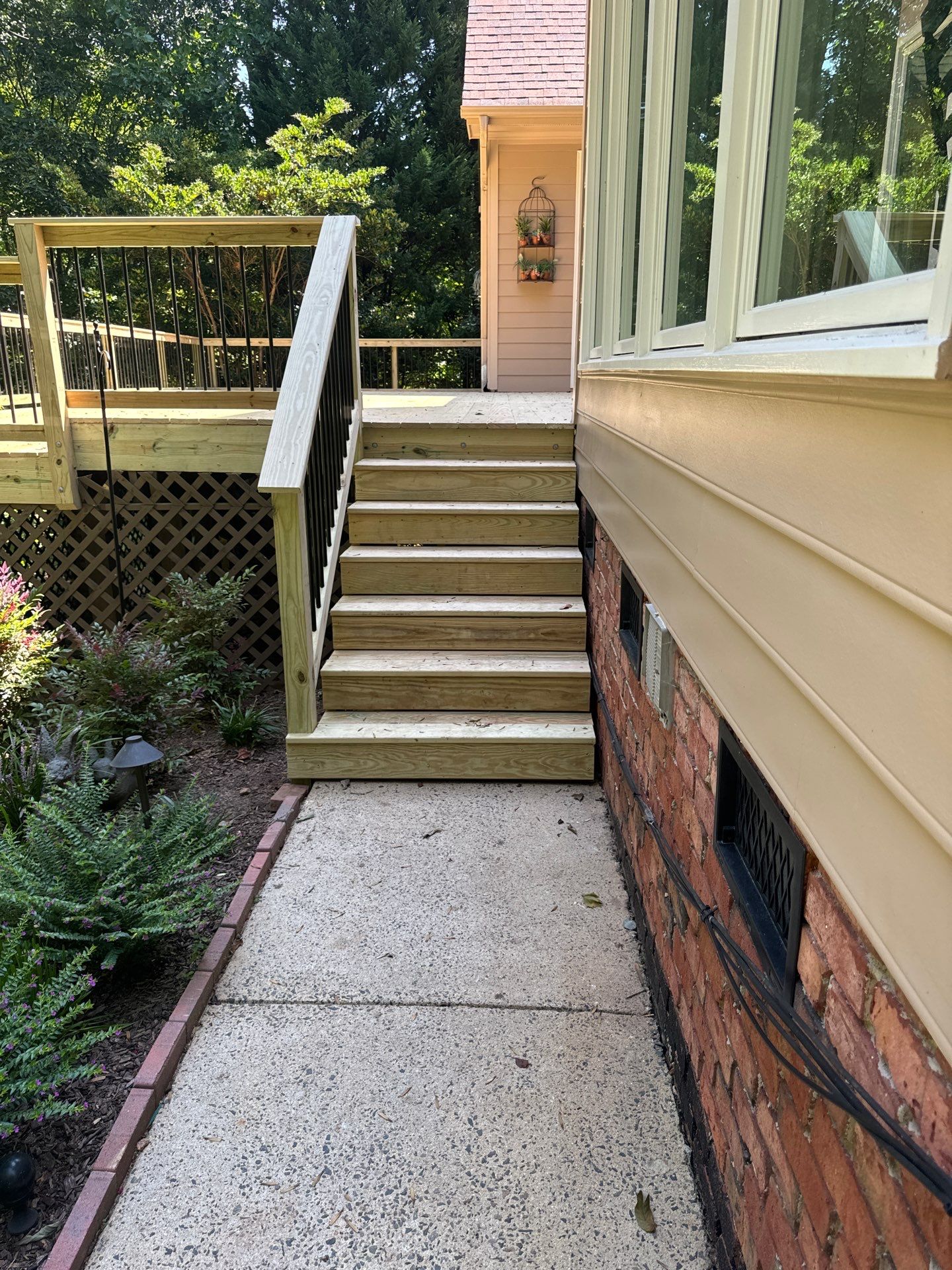 Pressure-Treated Deck Resurface with Black Aluminum Balusters in Broadway by The Remodeling Company