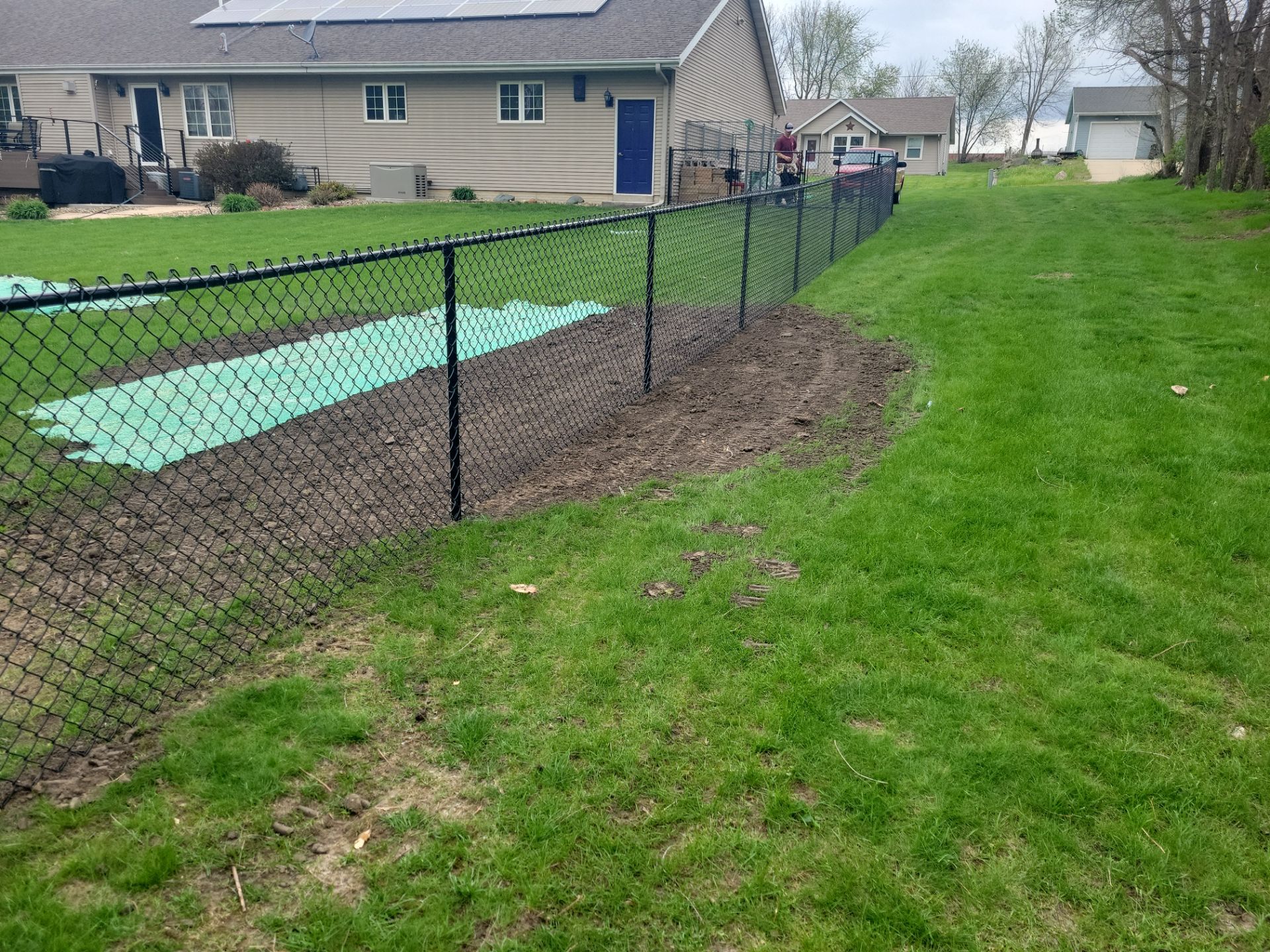 Residential Black Vinyl-Coated Chain Link Perimeter Fence in Garwin by Perfect Picket Fence and Stain