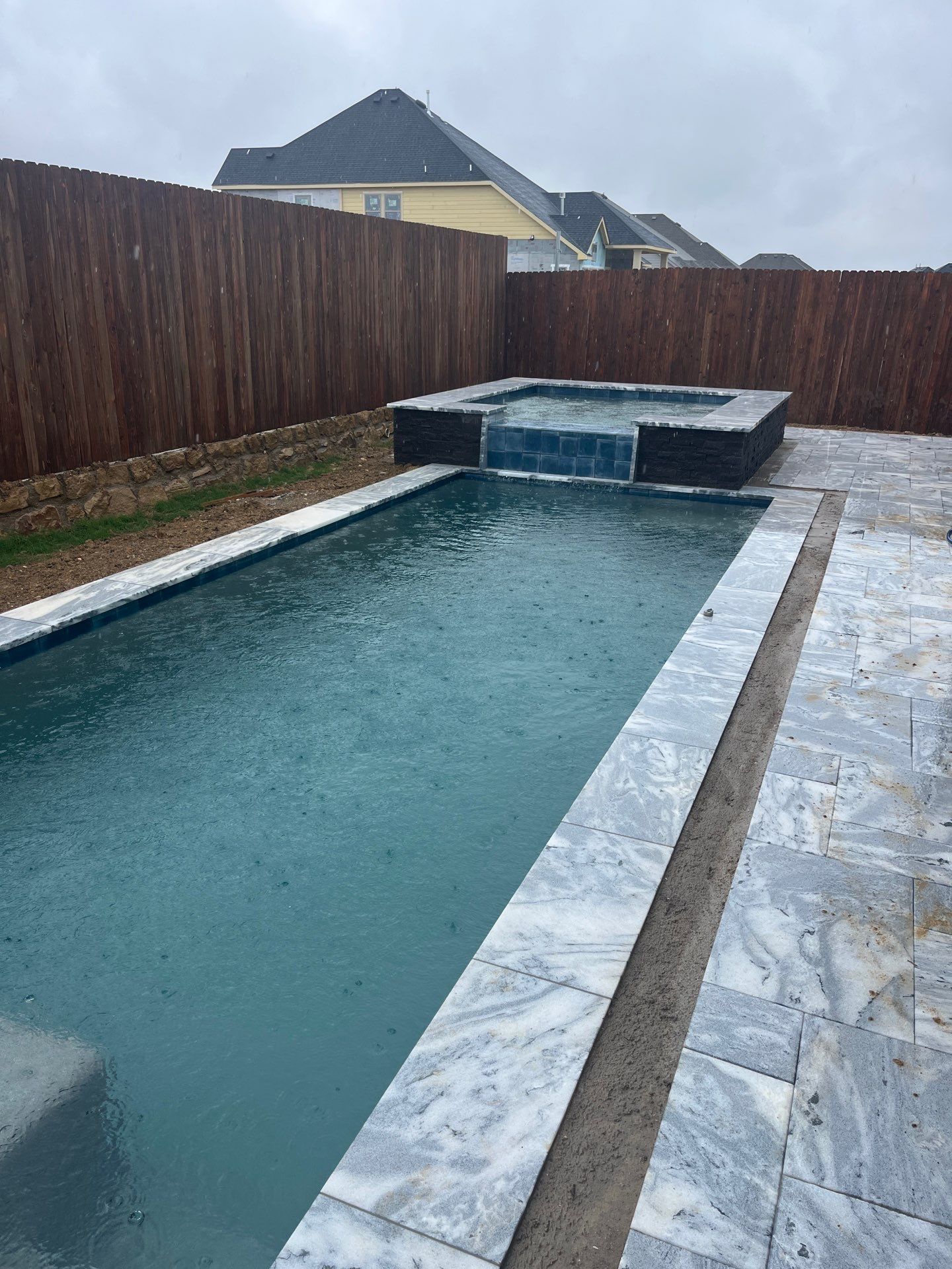 Geometric Pool with Raised Spa and Sheer Descent Waterfall by Pinnacle Pools and Spas - DFW