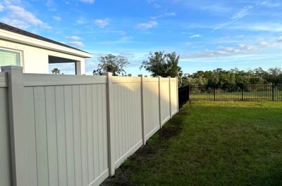 Vinyl Fence Installation using Vinyl Fence and a Black 3 Rail Aluminum Fence