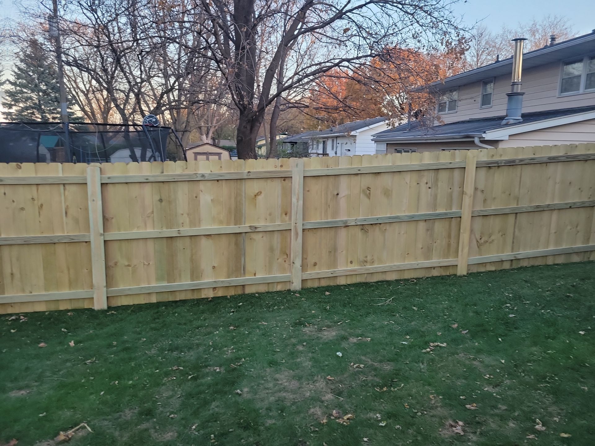 New Pressure-Treated Wood Privacy Fence and Gate in Charles City by Perfect Picket Fence and Stain