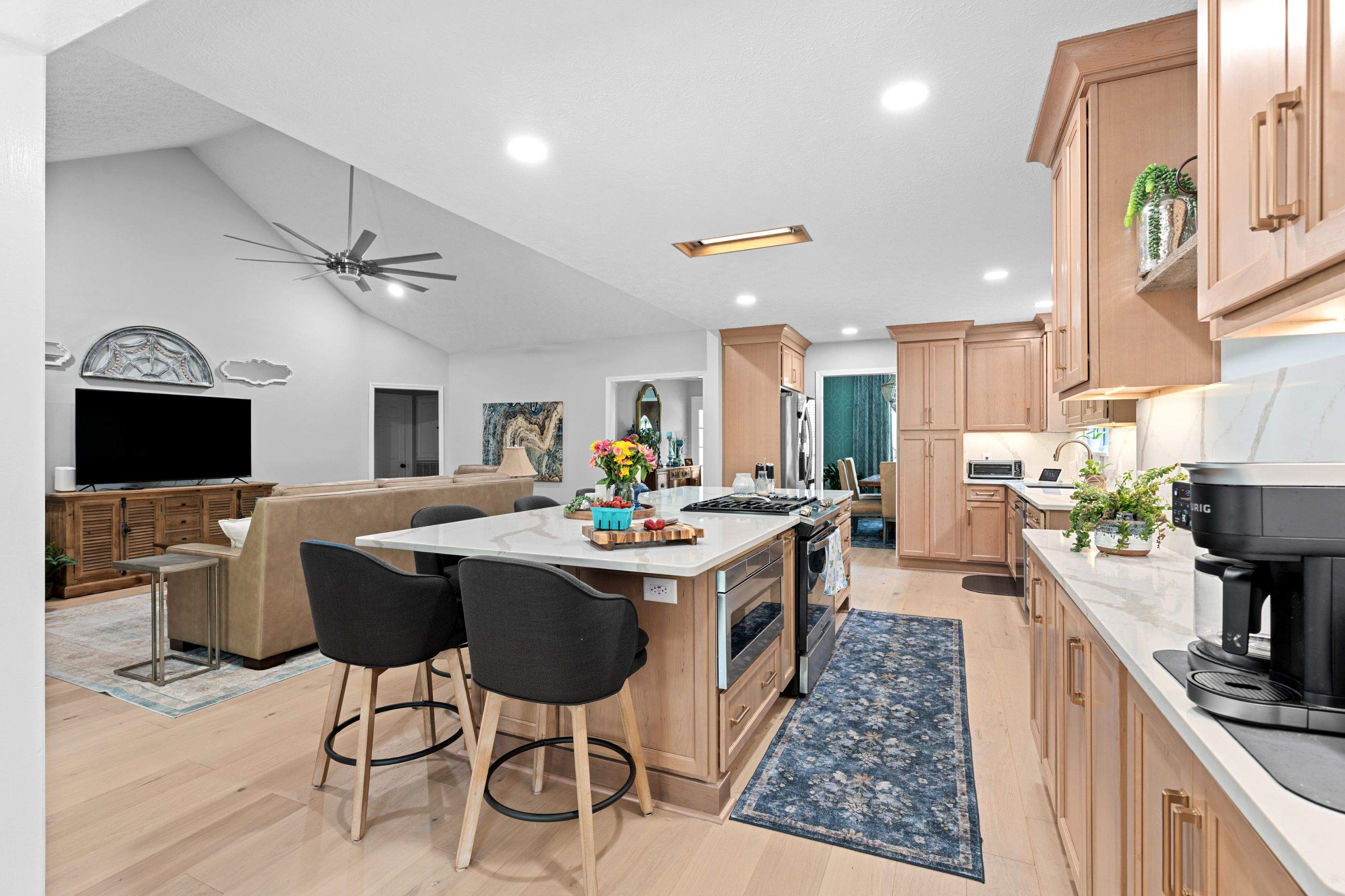 Modern Kitchen Remodel Featuring Quartz Backsplash, under cabinet lighintg, and a coffee bar in Mt. Juliet Tennessee by DeRo Renovations,LLC