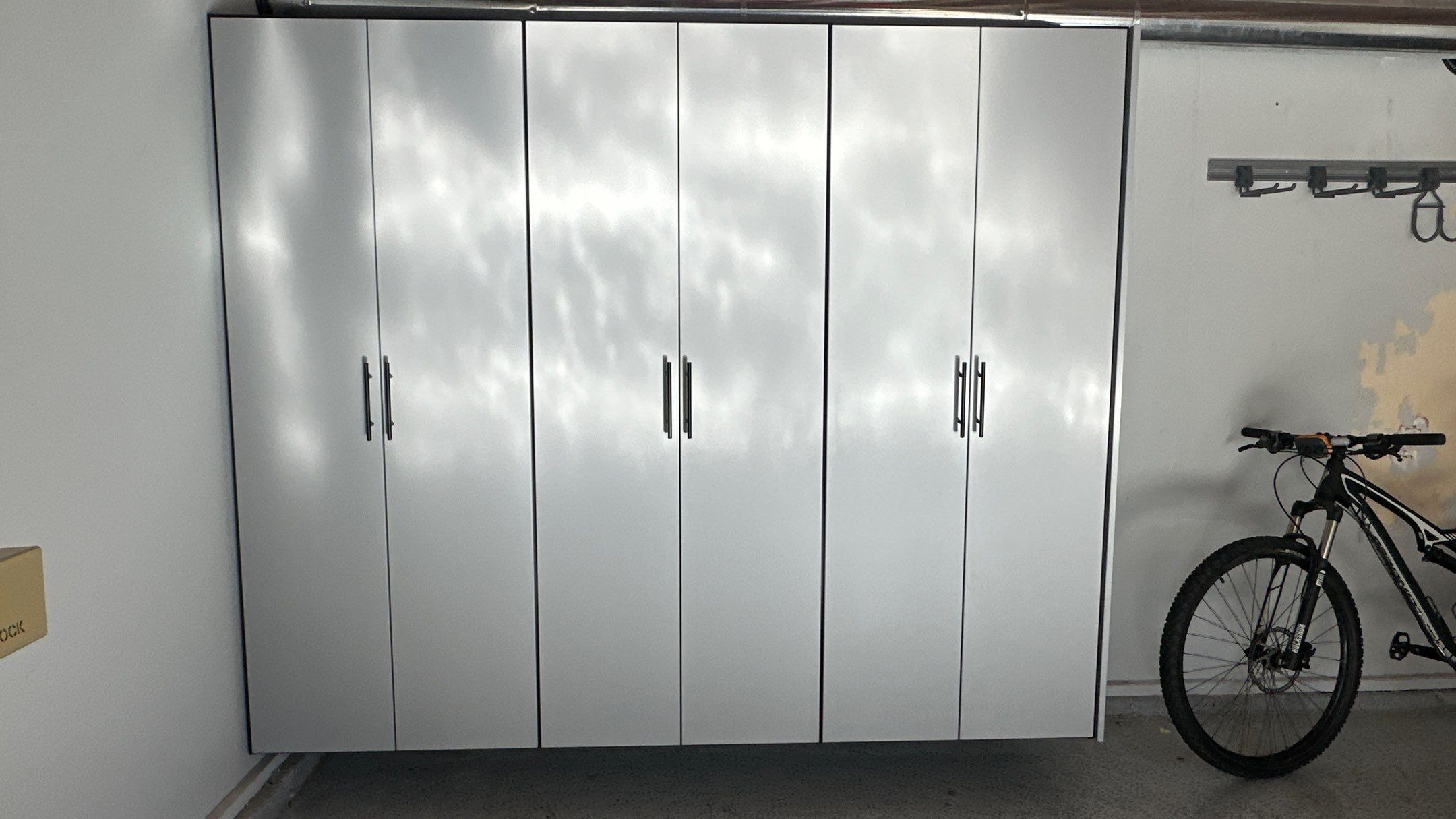 Jamie N added these beautiful cabinets for extra storage space by Banner Garage