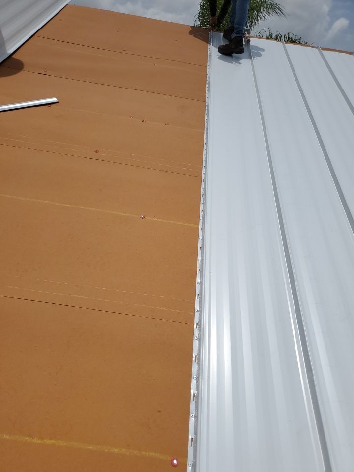 Residential Roofing Installation using 1.5" Nail Strip 24ga Solar White Kynar Coated Standing Seam Metal Panels by Morton Roofing, Inc.