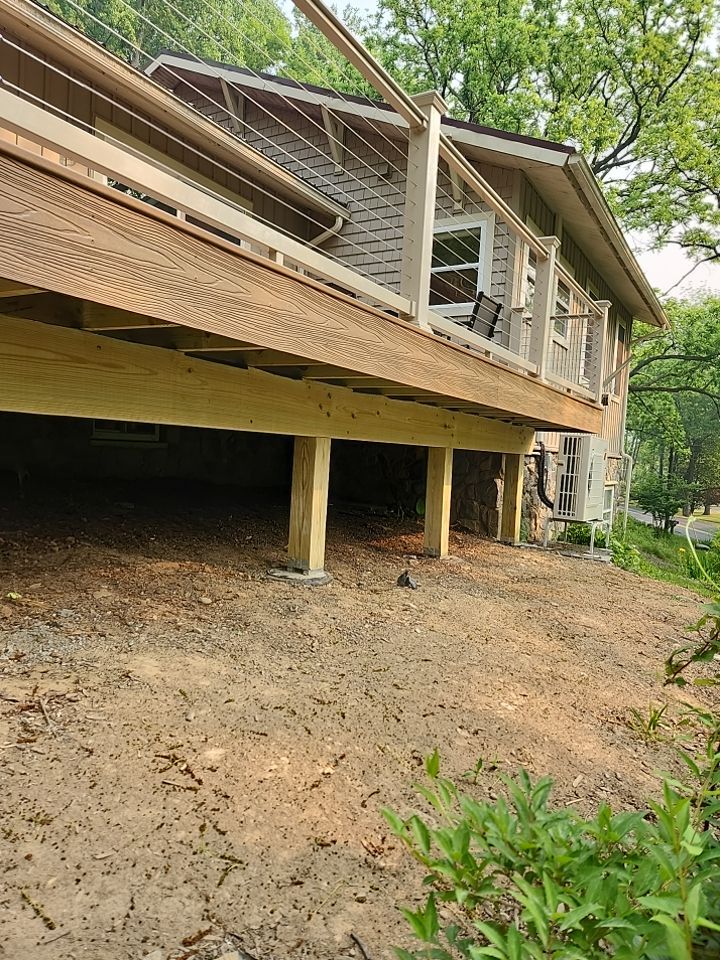 Deck installation using cable railing. by Burke Home Services