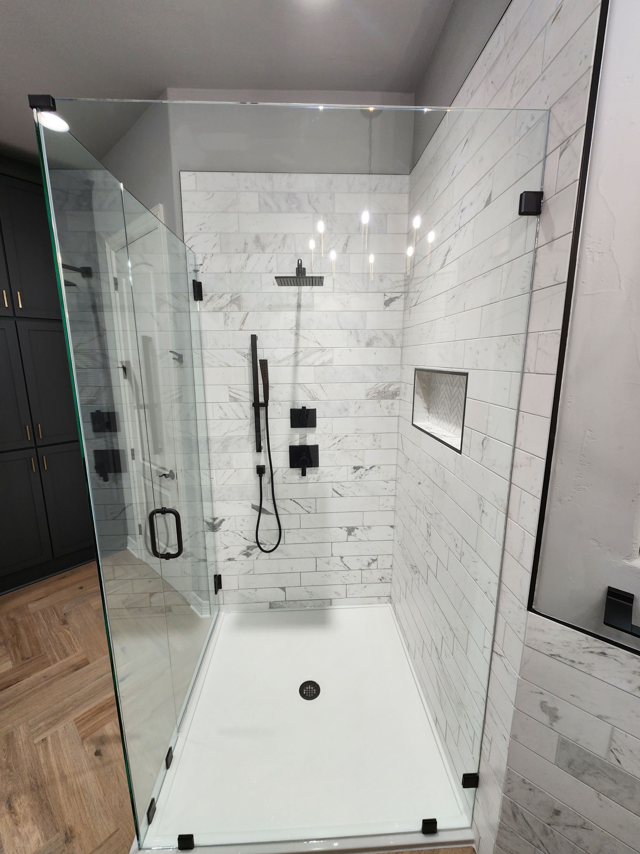 Spring Bathroom Remodel with Black Free-Standing Tub and Walk-In Shower by Legacy Bath and Kitchen