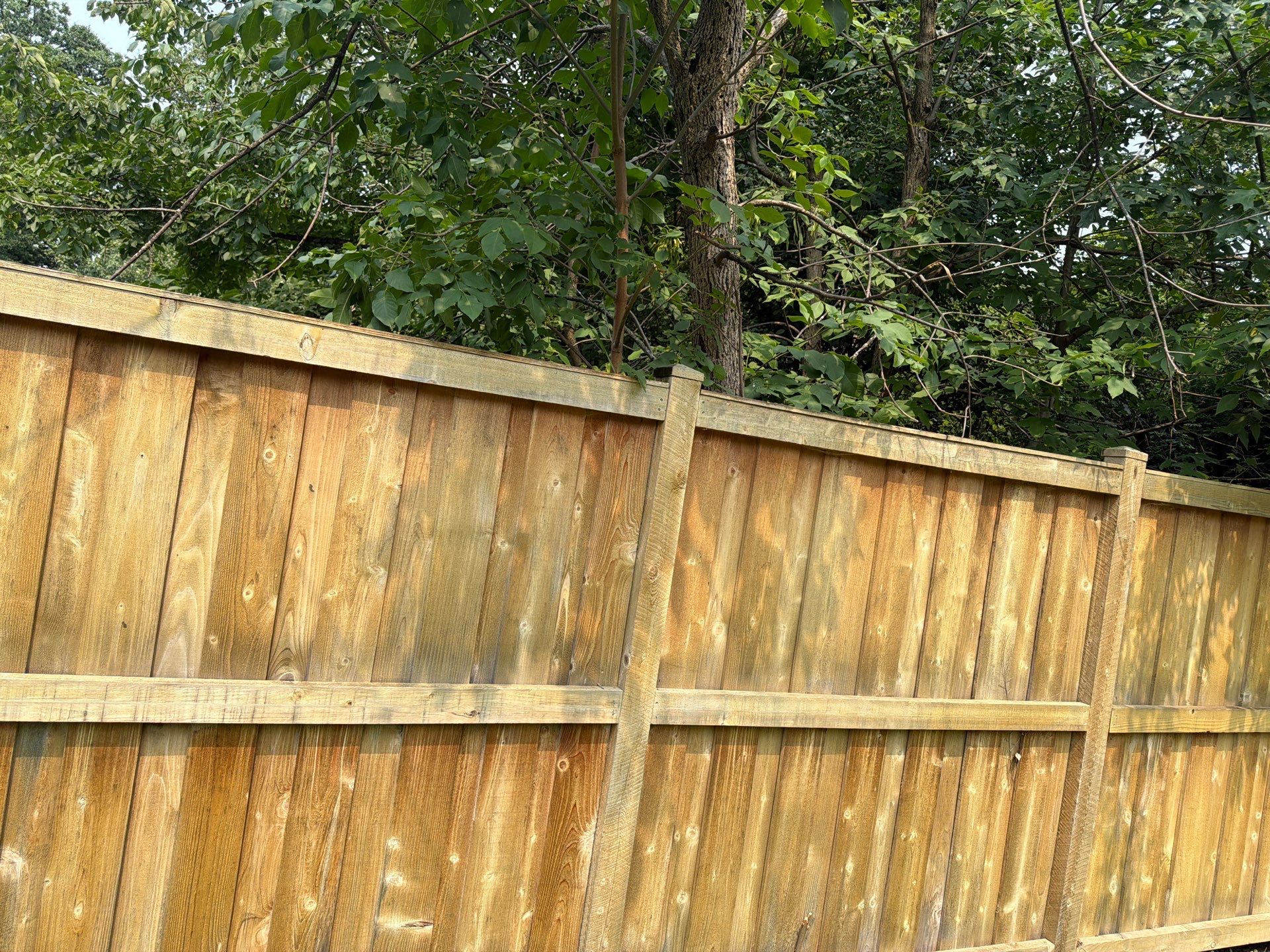 Wood fence cleaning and sealing by Northern Power Washing LLC.