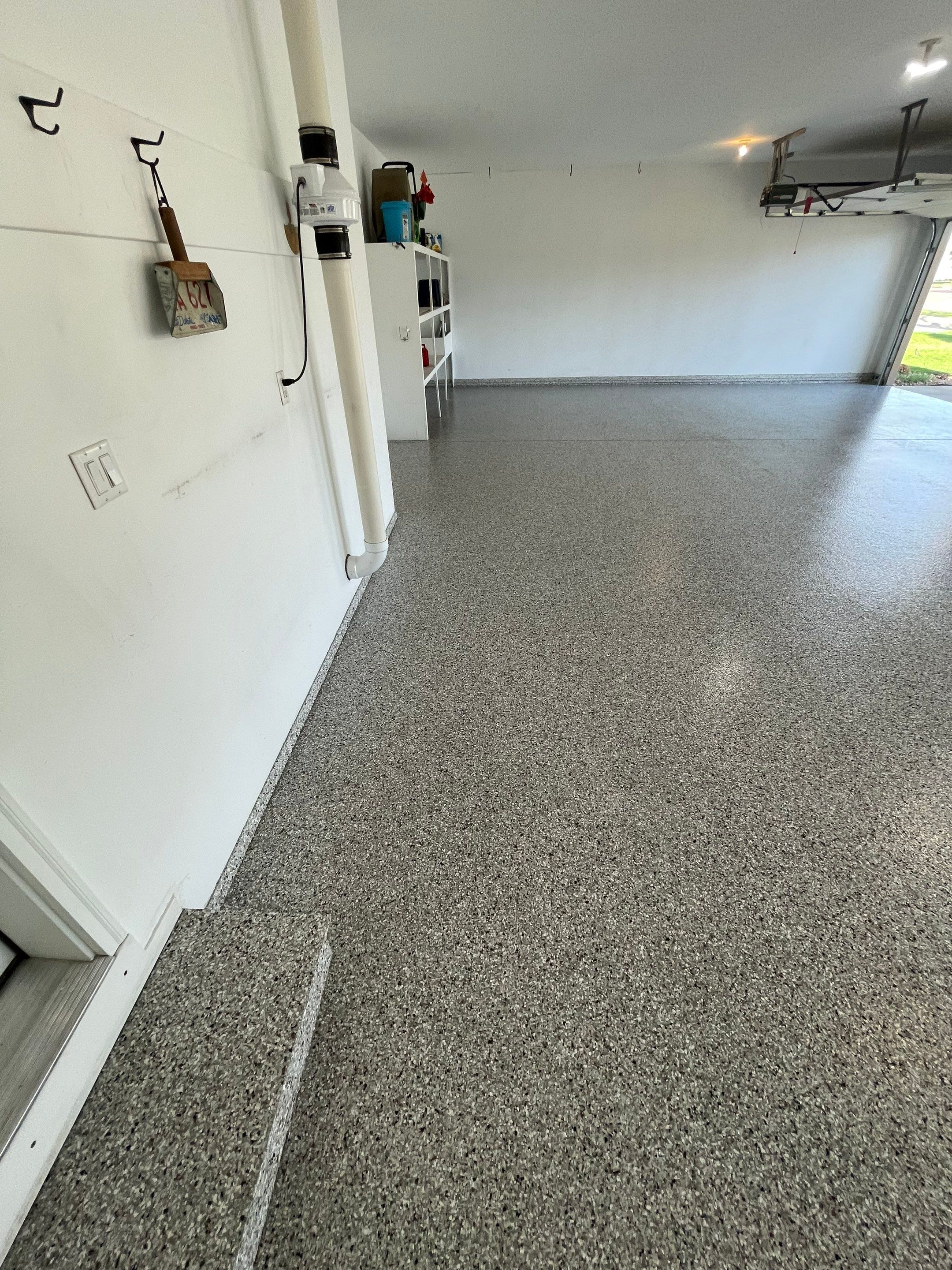 Yankton Garage Floor Restoration with Gray Speckled Epoxy Coating by Select Painting, Coatings & Garage Cabinets