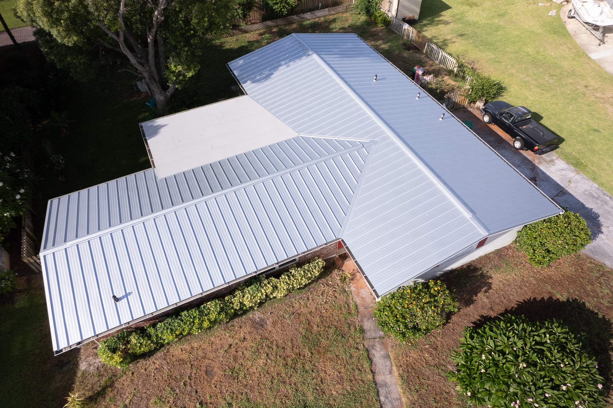 Standing Seam Metal Roof Replacement and New Gutters in Merritt Island by Wiedmann Construction & Roofing