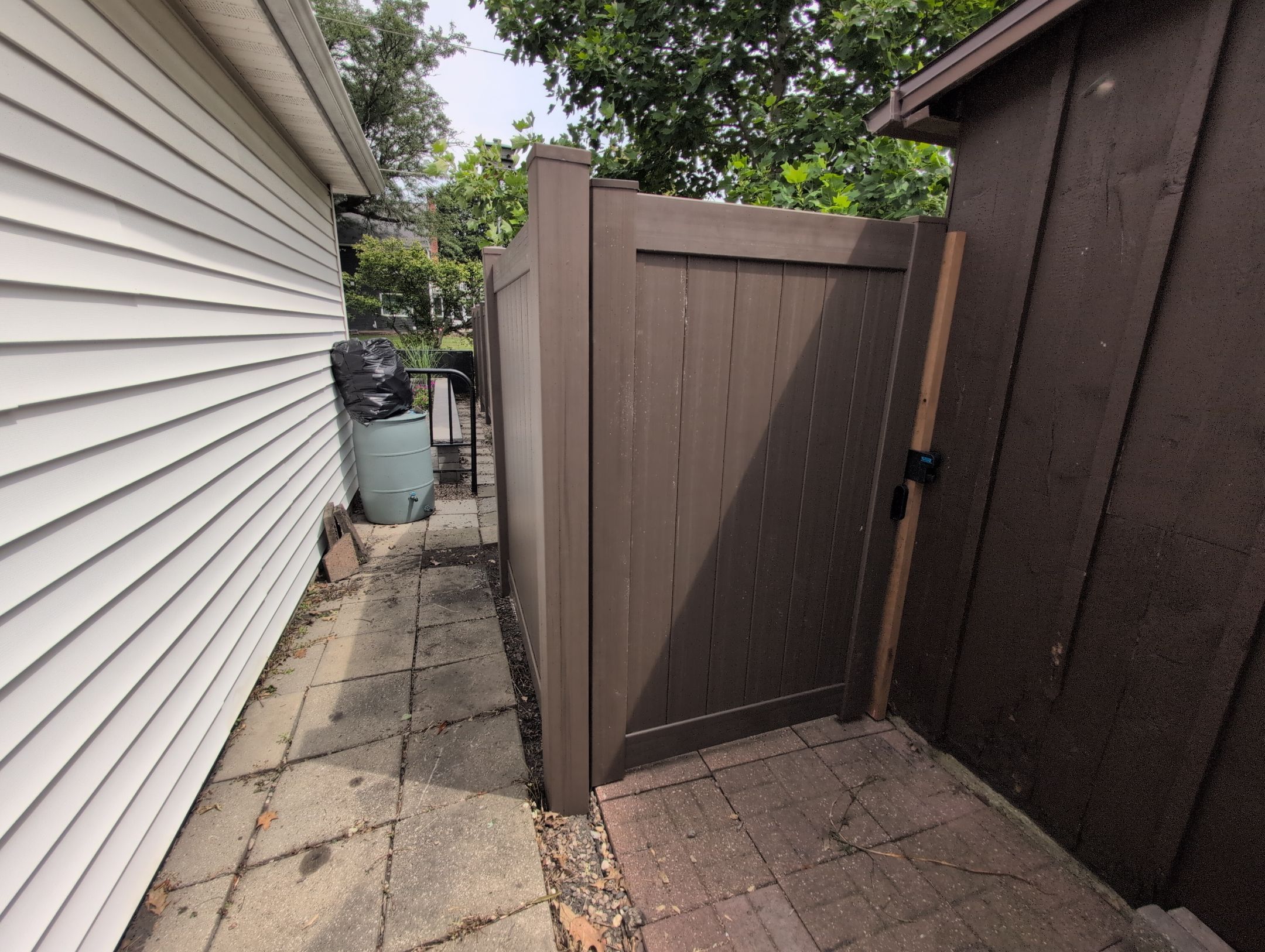 Walnut Vinyl Privacy Fence Installation in Waterloo by Perfect Picket Fence and Stain