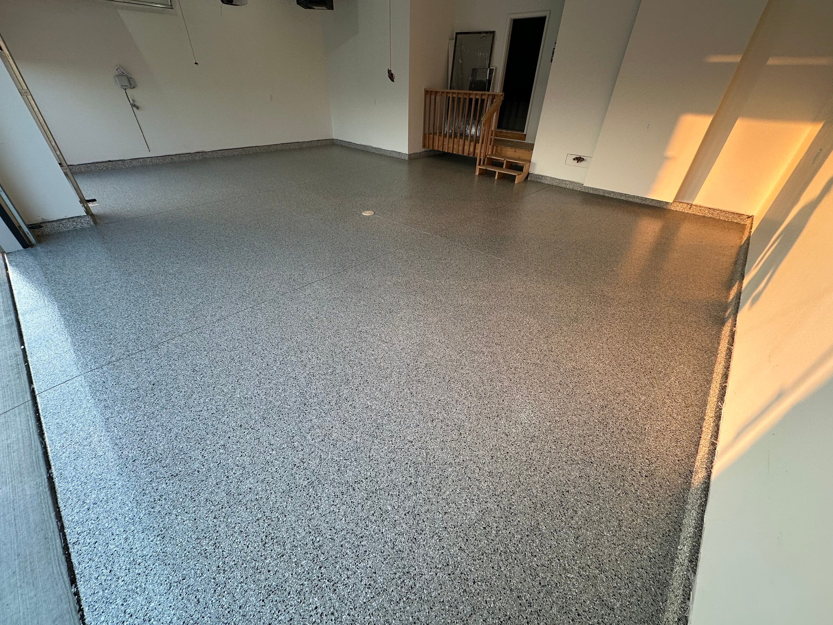 Cabin Fever Decorative Flake Garage Floor Coating in Sioux Falls by Select Painting, Coatings & Garage Cabinets